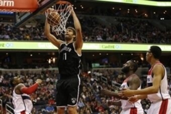 Jan 16, 2015; Washington, DC, USA; Brooklyn Nets center Brook Lopez (11) dunks the ball as Washington Wizards guard Bradley Beal (3), Wizards center DeJuan Blair (45), and Wizards forward Otto Porter Jr. (22) look on in the third quarter at Verizon Center