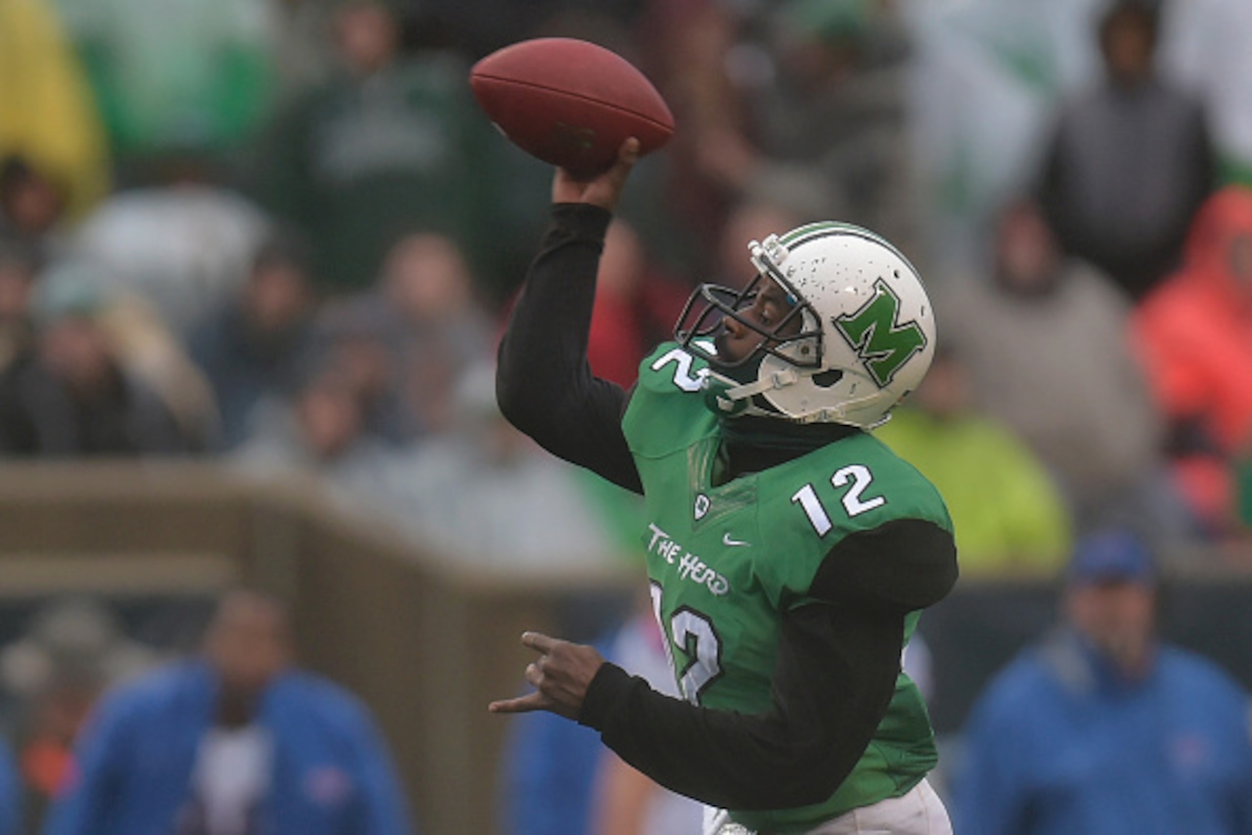 HUNTINGTON, WV - DECEMBER 06: Rakeem Cato #12 of the Marshall Thundering Herd makes a pass during the 4th quarter against the Louisiana Tech Bulldogs at Joan C. Edwards Stadium during the Conference USA championship game on December 6, 2014 in Huntington,