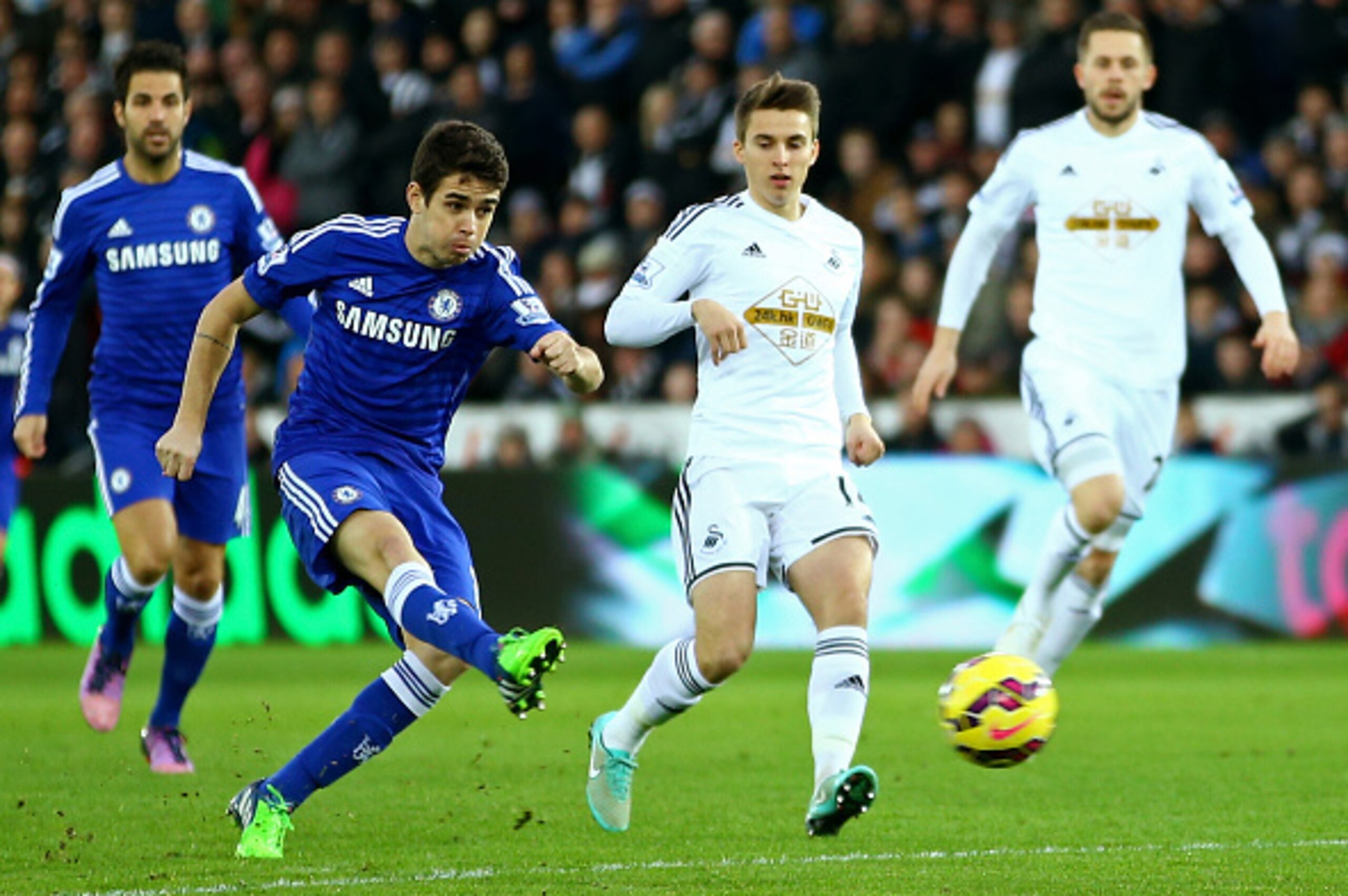 SWANSEA, WALES - JANUARY 17:  Oscar of Chelsea scores his team's first goal during the Barclays Premier League match between Swansea City and Chelsea at Liberty Stadium on January 17, 2015 in Swansea, Wales.  (Photo by Richard Heathcote/Getty Images)