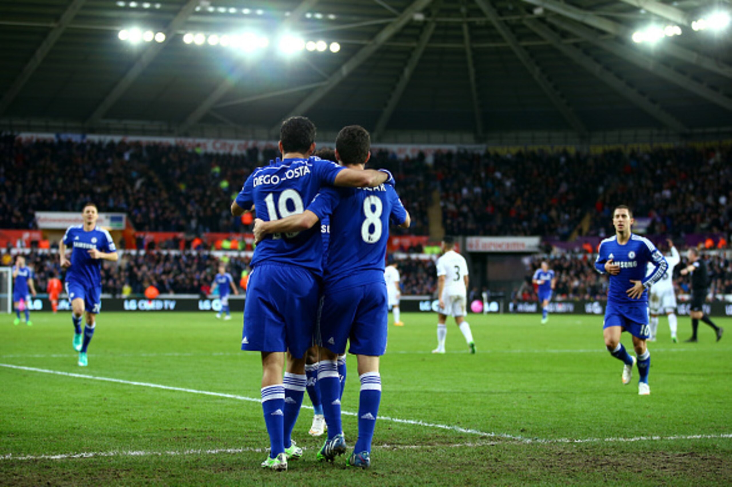 SWANSEA, WALES - JANUARY 17:  Oscar of Chelsea celebrates with Diego Costa of Chelsea after scoring his team's fourth goal during the Barclays Premier League match between Swansea City and Chelsea at Liberty Stadium on January 17, 2015 in Swansea, Wales. 