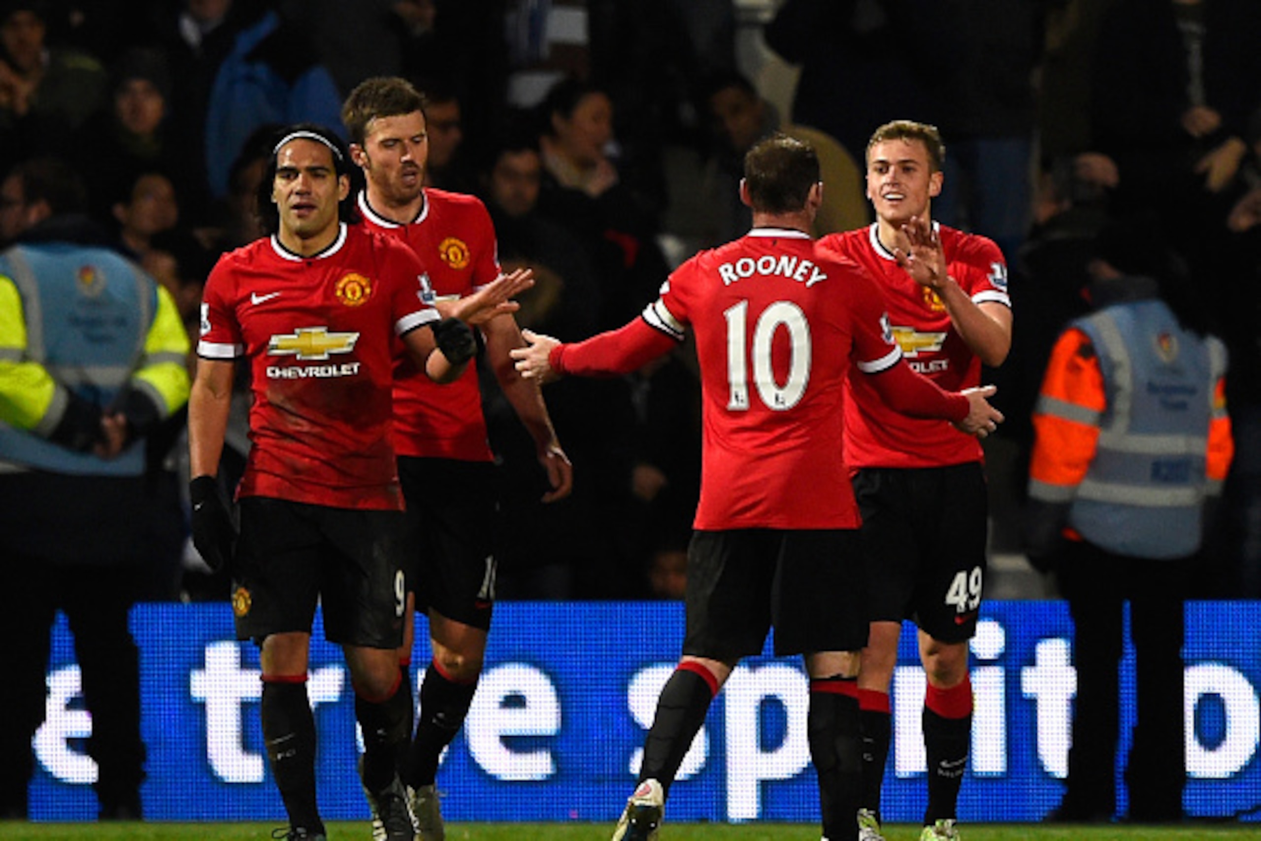 LONDON, ENGLAND - JANUARY 17:  James Wilson of Manchester United celebrates with team-mates after scoring his team's second goal past Robert Green of QPR during the Barclays Premier League match between Queens Park Rangers and Manchester United at Loftus 
