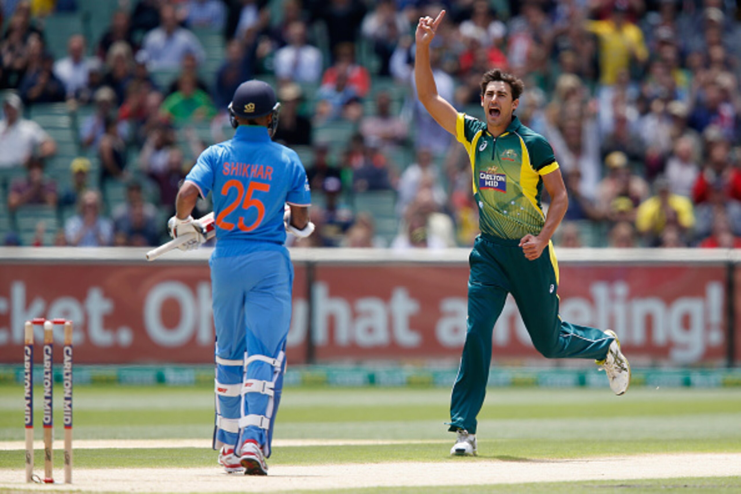 MELBOURNE, AUSTRALIA - JANUARY 18:  Mitchell Starc of Australia celebrates taking the wicket of Shikhar Dhawan of India during the One Day International match between Australia and India at Melbourne Cricket Ground on January 18, 2015 in Melbourne, Austra