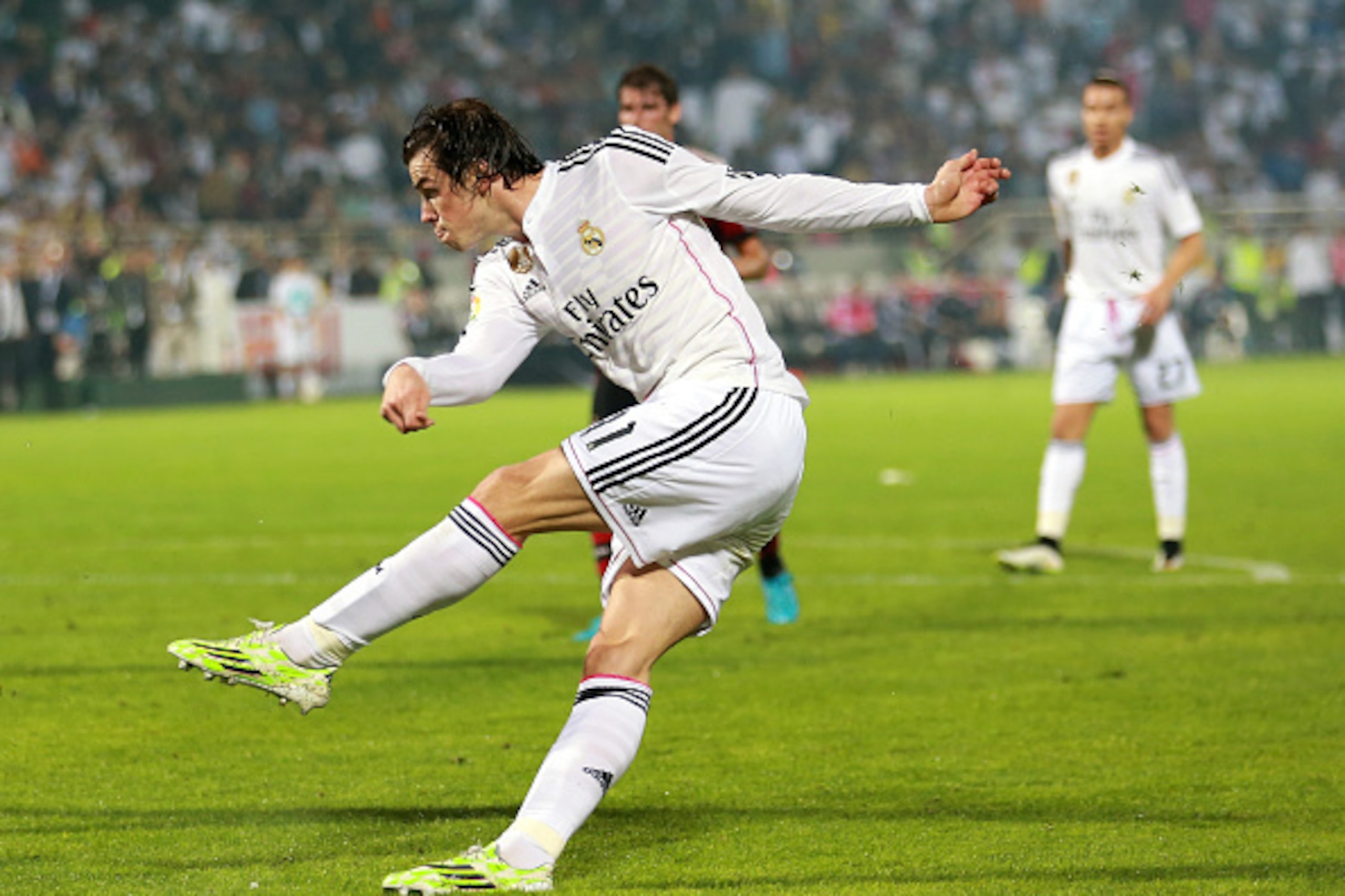 DUBAI, UNITED ARAB EMIRATES - DECEMBER 30:  Gareth Bale of Real Madrid strikes at goal during the Dubai Football Challenge match between AC Milan and Real Madrid at The Sevens Stadium on December 30, 2014 in Dubai, United Arab Emirates.  (Photo by Warren 