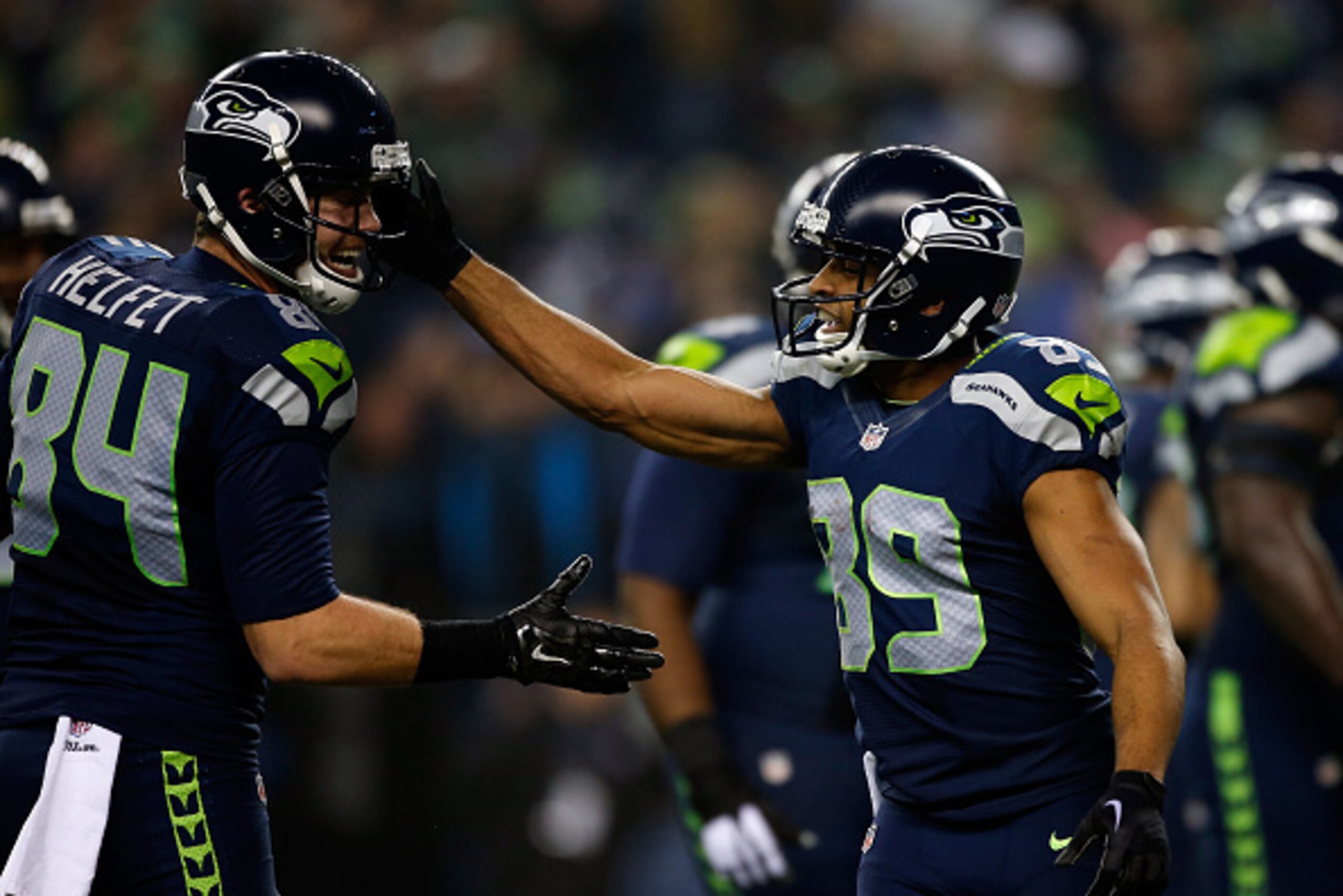 SEATTLE, WA - JANUARY 10:  Doug Baldwin #89 of the Seattle Seahawks celebrates with Cooper Helfet #84 after catching a 16 yard touchdown pass from Russell Wilson #3 in the first quarter against the Carolina Panthers during the 2015 NFC Divisional Playoff 