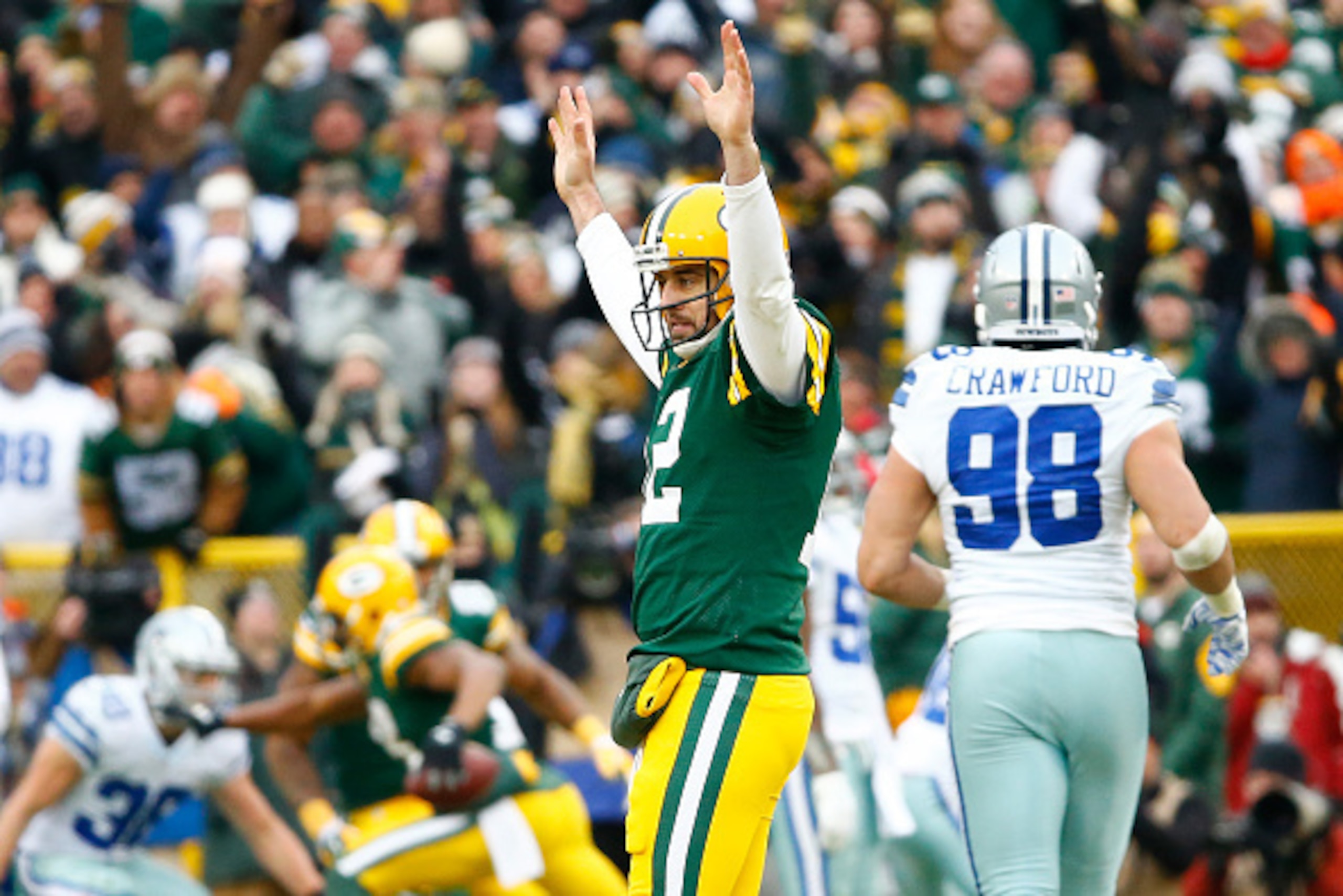 GREEN BAY, WI - JANUARY 11:  Aaron Rodgers #12 of the Green Bay Packers reacts after completing a pass against the Dallas Cowboys during the 2015 NFC Divisional Playoff game at Lambeau Field on January 11, 2015 in Green Bay, Wisconsin.  The Packers defeat
