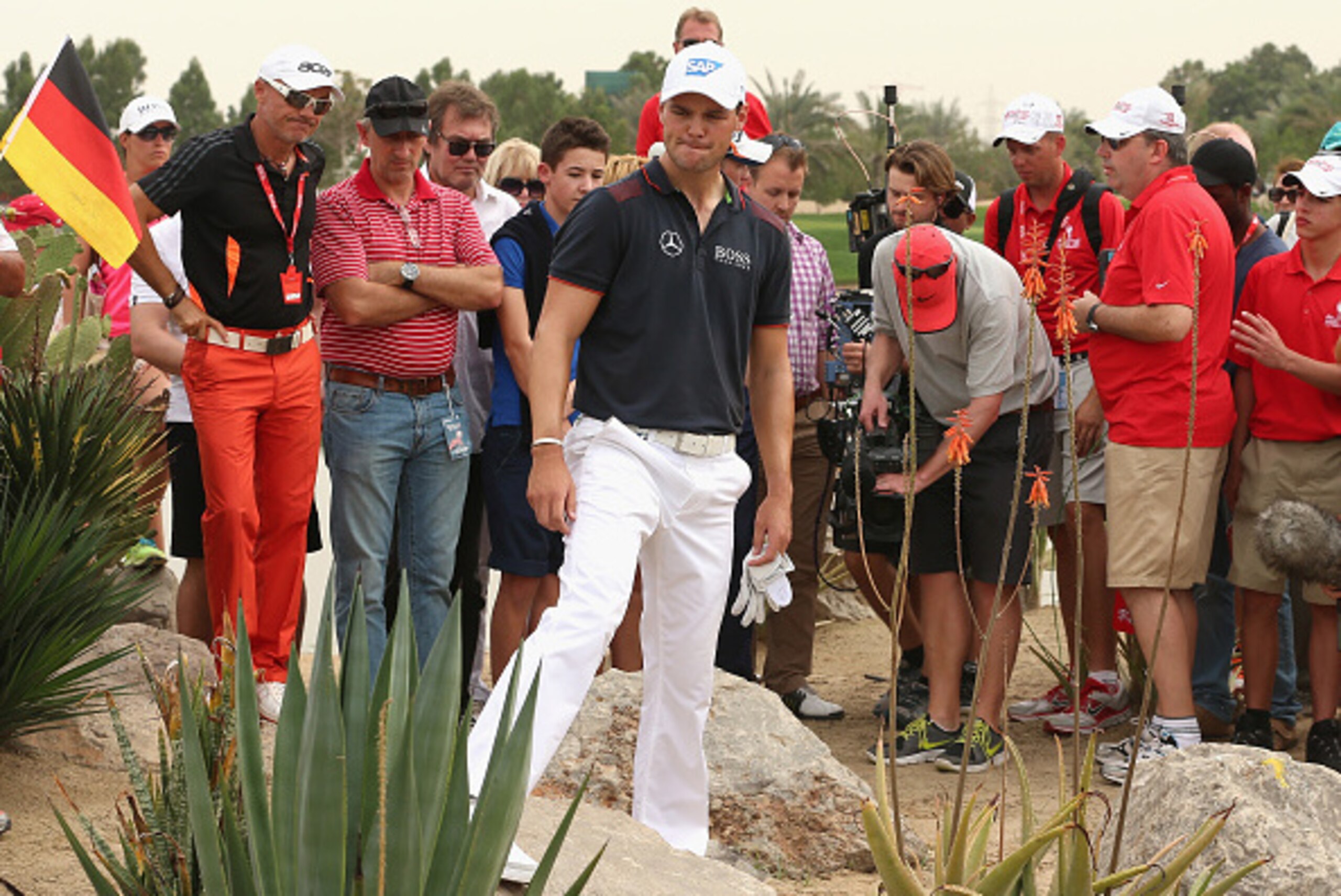 ABU DHABI, UNITED ARAB EMIRATES - JANUARY 18:  Martin Kaymer of Germany inspects his ball after driving into trouble on the ninth hole during the final round of the Abu Dhabi HSBC Golf Championship at the Abu Dhabi Golf Cub on January 18, 2015 in Abu Dhab