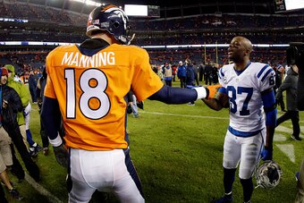 DENVER, CO - JANUARY 11: Peyton Manning #18 of the Denver Broncos meets Reggie Wayne #87 of the Indianapolis Colts following a 2015 AFC Divisional Playoff game at Sports Authority Field at Mile High on January 11, 2015 in Denver, Colorado. The Colts defea