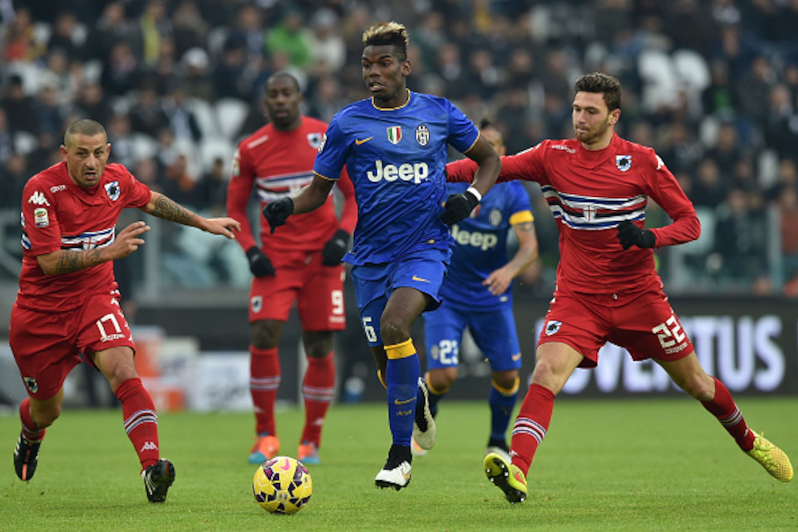 TURIN, ITALY - DECEMBER 14:  Paul Pogba (C) of Juventus FC in action against Angelo Palombo (L) and Luca Rizzo of UC Sampdoria during the Serie A match between Juventus FC and UC Sampdoria at Juventus Arena on December 14, 2014 in Turin, Italy.  (Photo by