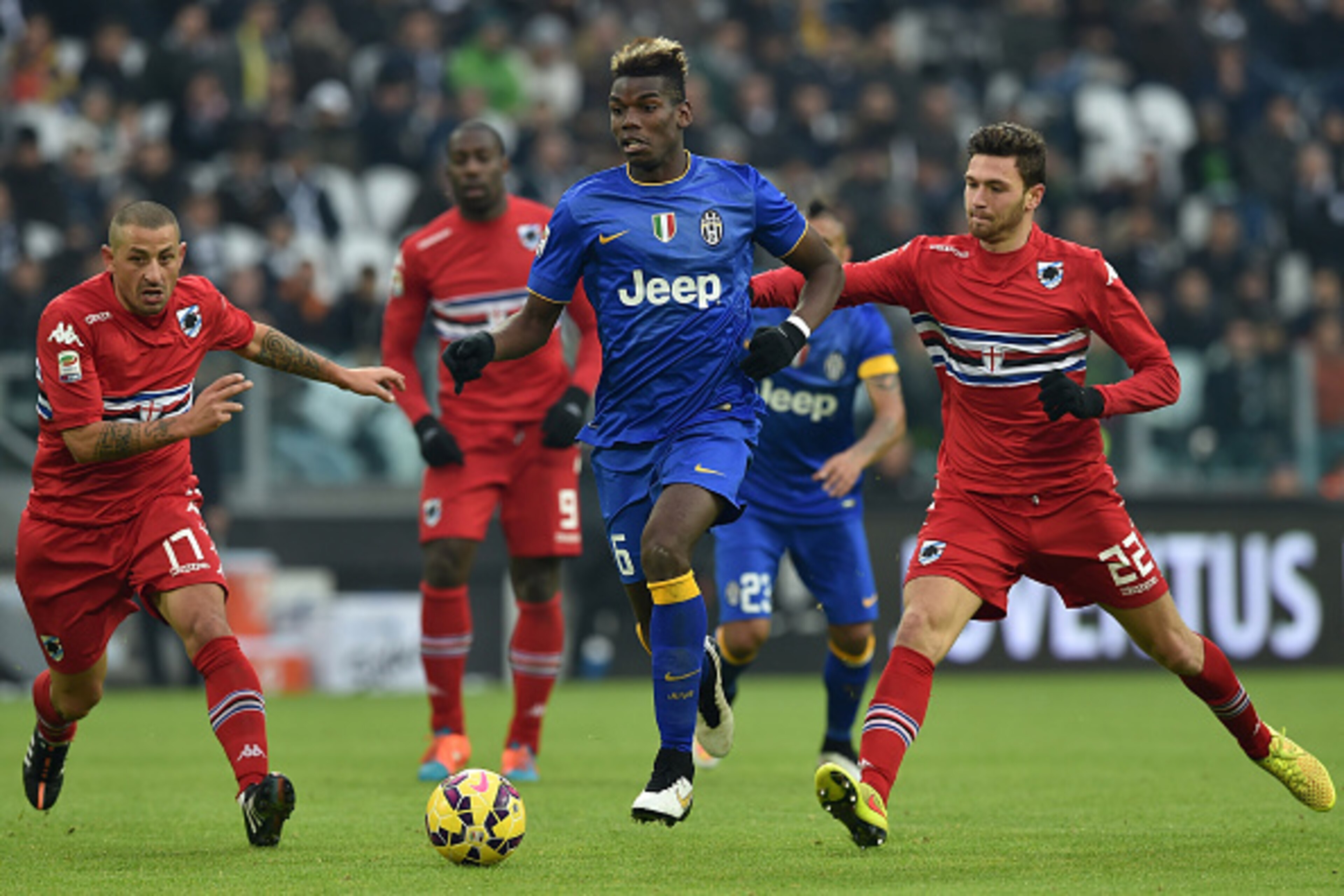 TURIN, ITALY - DECEMBER 14:  Paul Pogba (C) of Juventus FC in action against Angelo Palombo (L) and Luca Rizzo of UC Sampdoria during the Serie A match between Juventus FC and UC Sampdoria at Juventus Arena on December 14, 2014 in Turin, Italy.  (Photo by