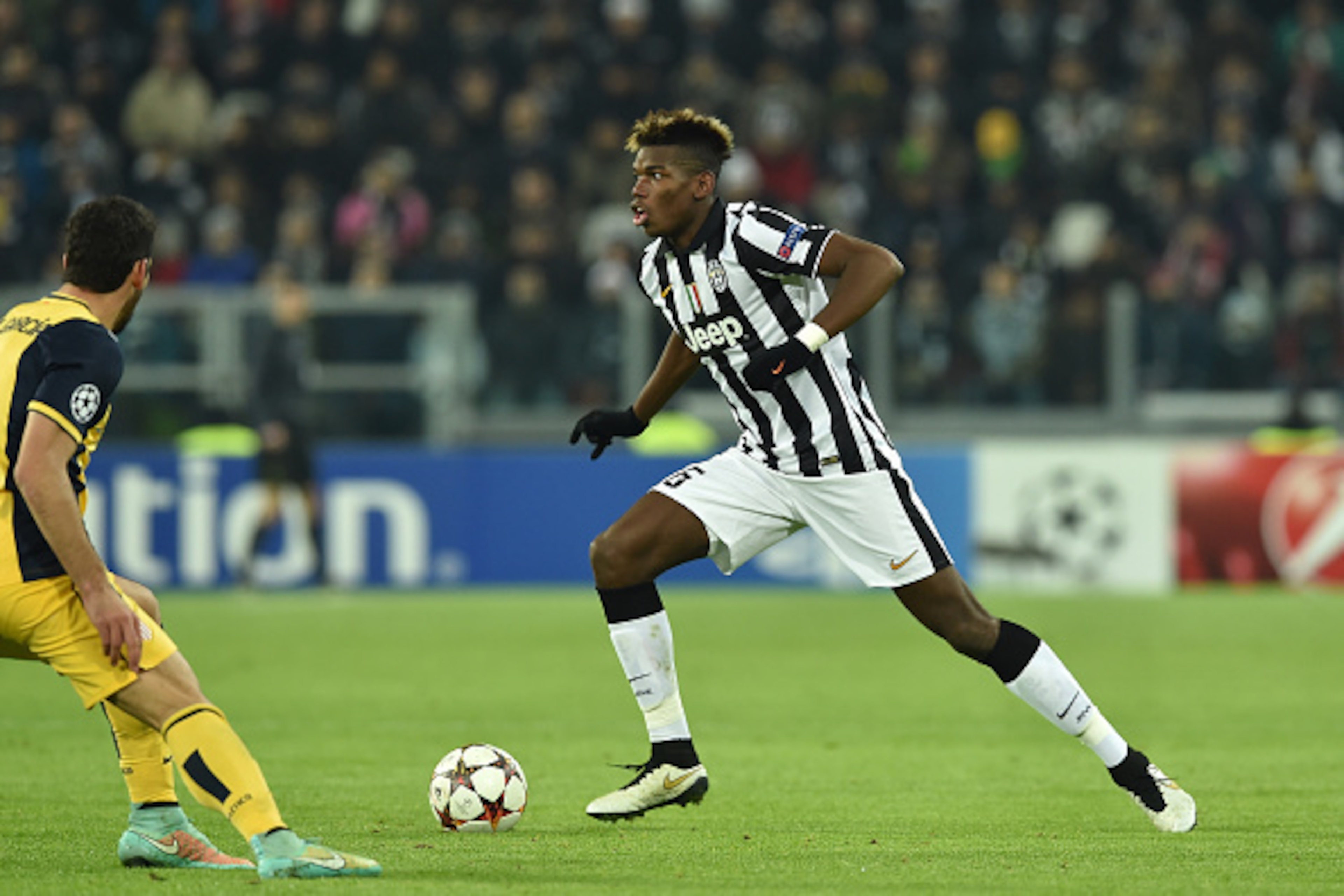 TURIN, ITALY - DECEMBER 09:  Paul Pogba of Juventus in action during the UEFA Champions League group A match between Juventus and Club Atletico de Madrid at Juventus Arena on December 9, 2014 in Turin, Italy.  (Photo by Valerio Pennicino/Getty Images)