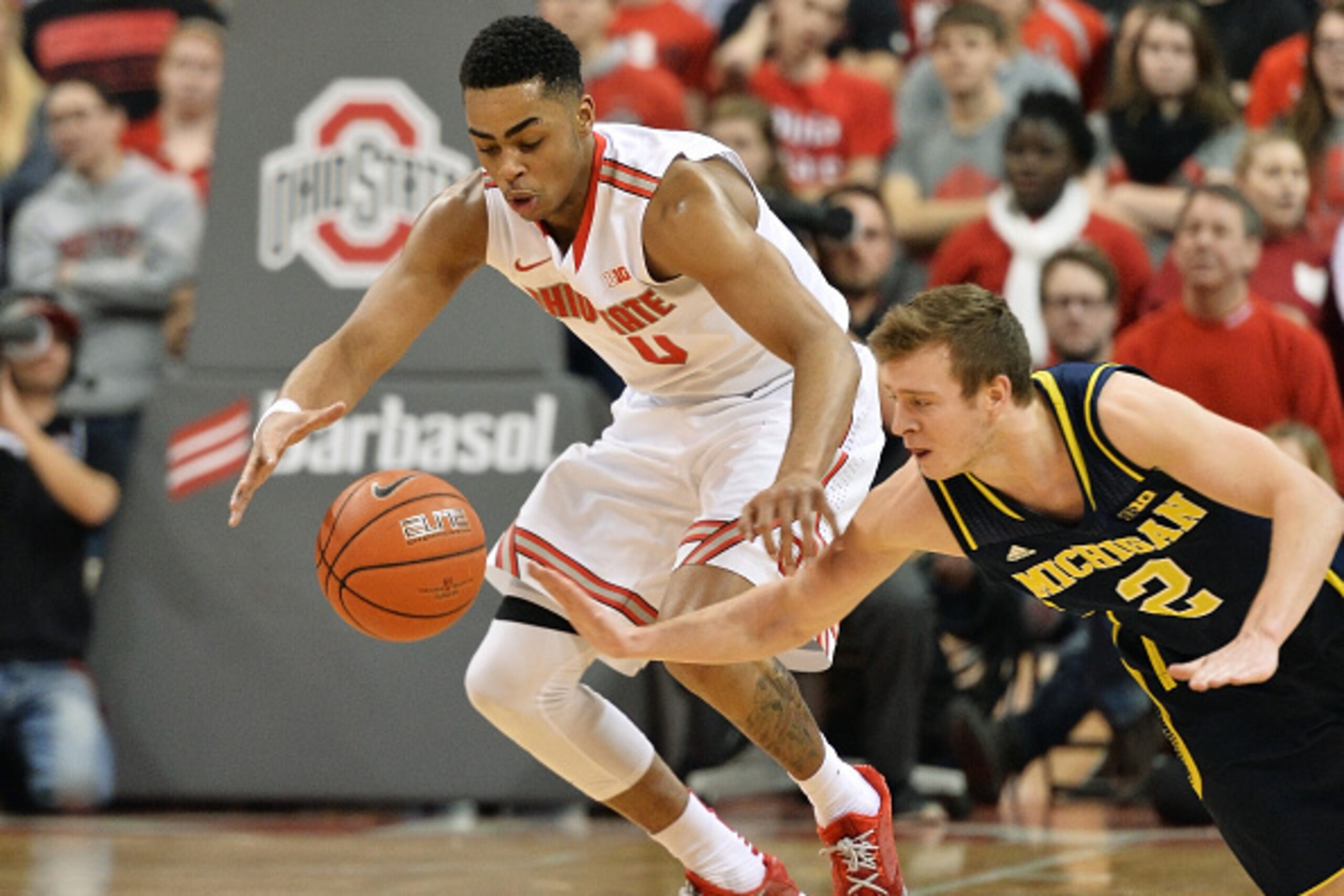 COLUMBUS, OH - JANUARY 13:  D'Angelo Russell #0 of the Ohio State Buckeyes and Spike Albrecht #2 of the Michigan Wolverines battle for control of a loose ball in the second half on January 13, 2015 at Value City Arena in Columbus, Ohio. Ohio State defeate