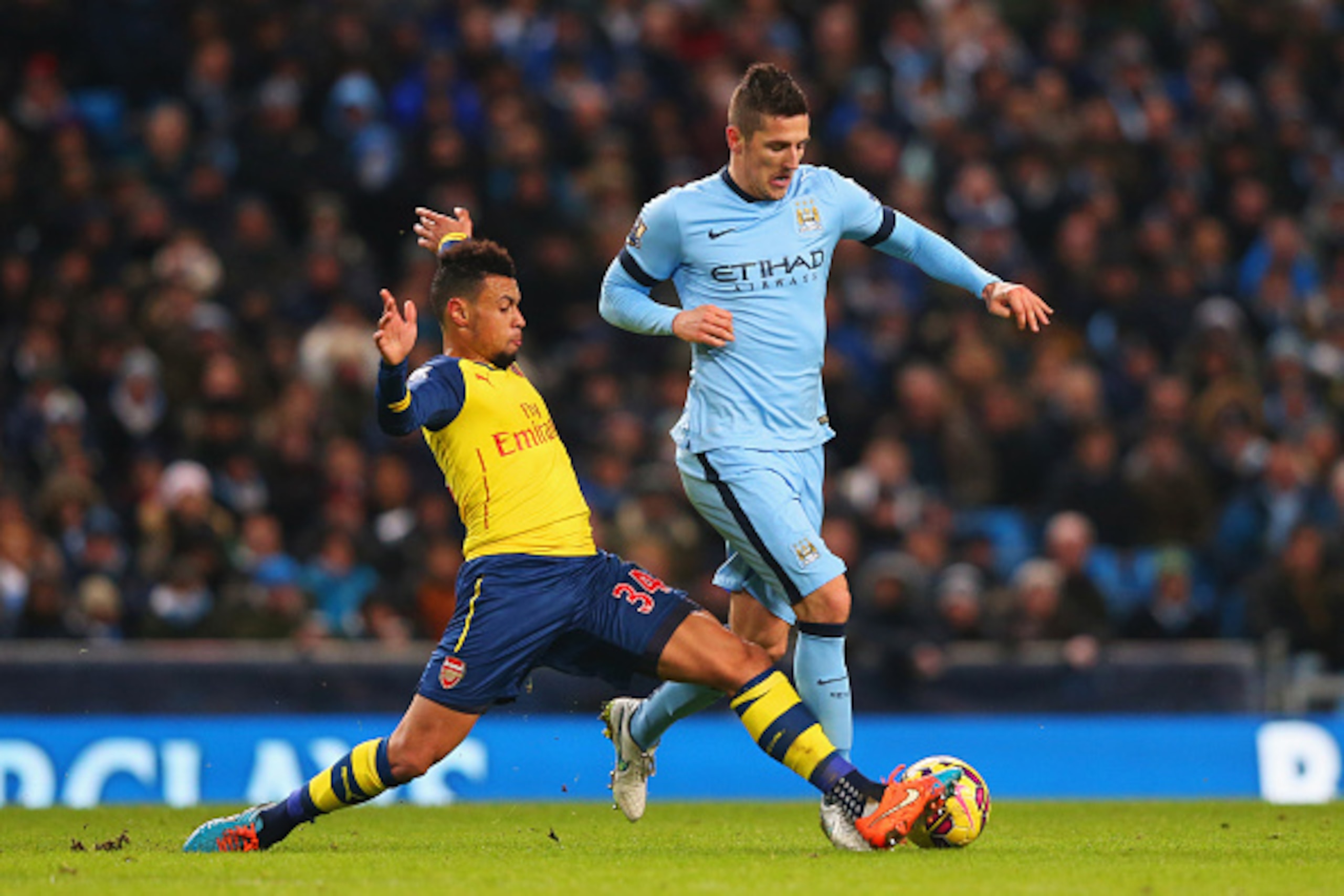 MANCHESTER, ENGLAND - JANUARY 18:  Stevan Jovetic of Manchester City is tackled by Francis Coquelin of Arsenal during the Barclays Premier League match between Manchester City and Arsenal at Etihad Stadium on January 18, 2015 in Manchester, England.  (Pho