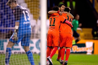 LA CORUNA, SPAIN - JANUARY 18:  Lionel Messi (R) of FC Barcelona celebrates scoring their opening goal with teammate Neymar JR. (L) and Luis Suarez (2ndL)  during the La Liga match between RC Deportivo La Coruna and FC Barcelona at Riazor Stadium on Janua