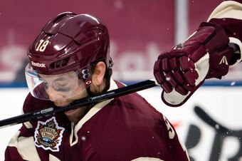 The Vancouver Canucks' Ryan Stanton takes a stick to the face from a teammate in the Heritage Classic against Ottawa in March 2014.