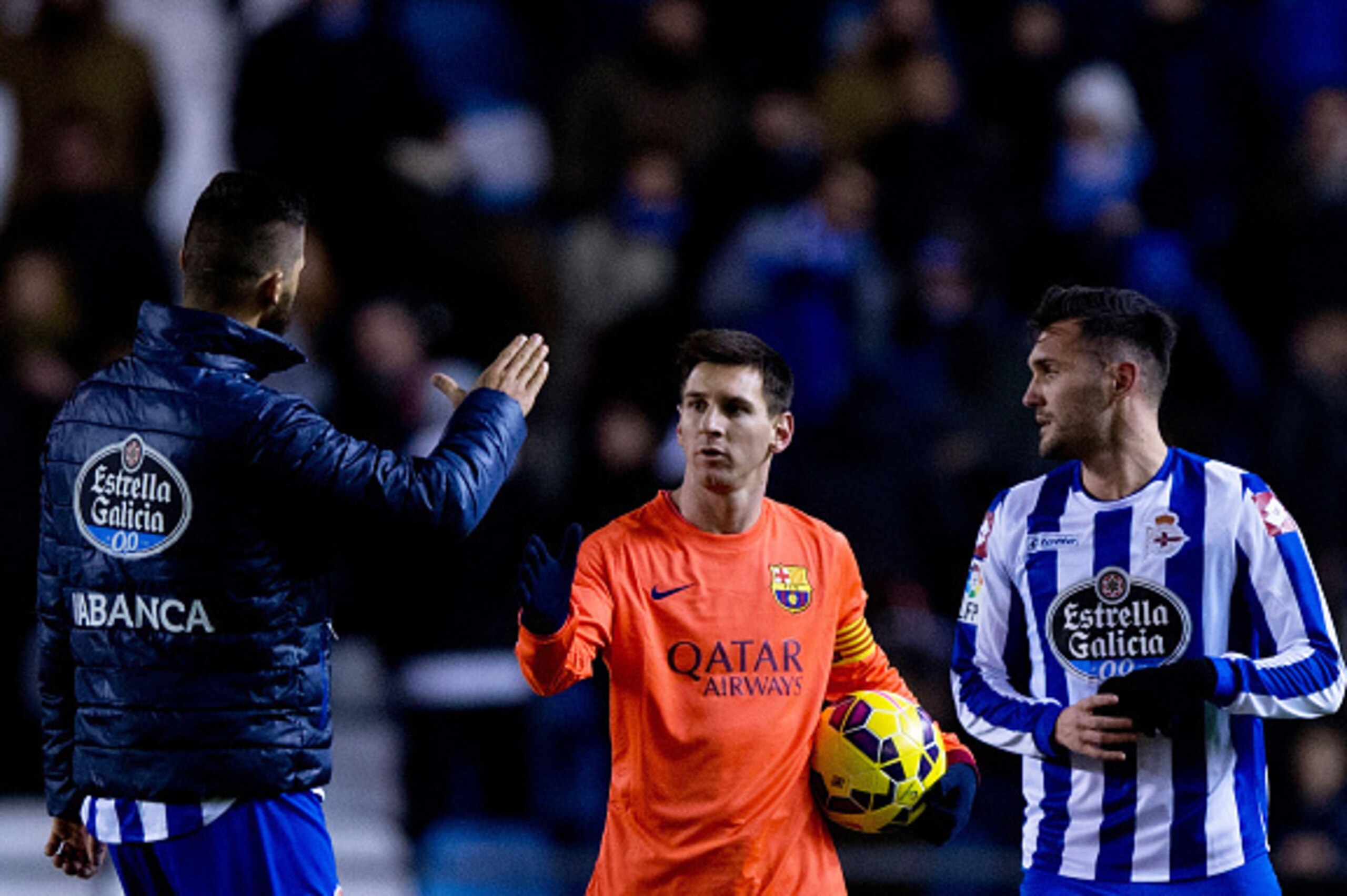 LA CORUNA, SPAIN - JANUARY 18:  Lionel Messi (2ndL) of FC Barcelona shake hands with Haris Medunjanin (L) of RC Deportivo La Coruna as he holds the ball after his hat-trick at the end of the La Liga match between RC Deportivo La Coruna and FC Barcelona at