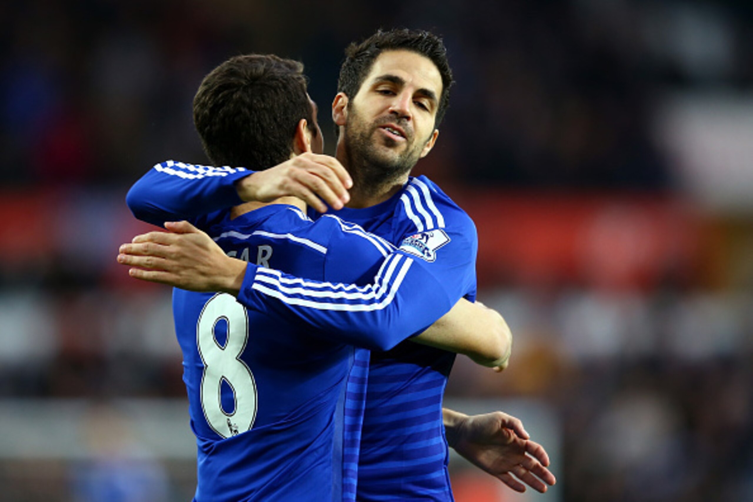 SWANSEA, WALES - JANUARY 17:  Oscar of Chelsea celebrates with Cesc Fabregas of Chelsea after scoring his team's first goal during the Barclays Premier League match between Swansea City and Chelsea at Liberty Stadium on January 17, 2015 in Swansea, Wales.