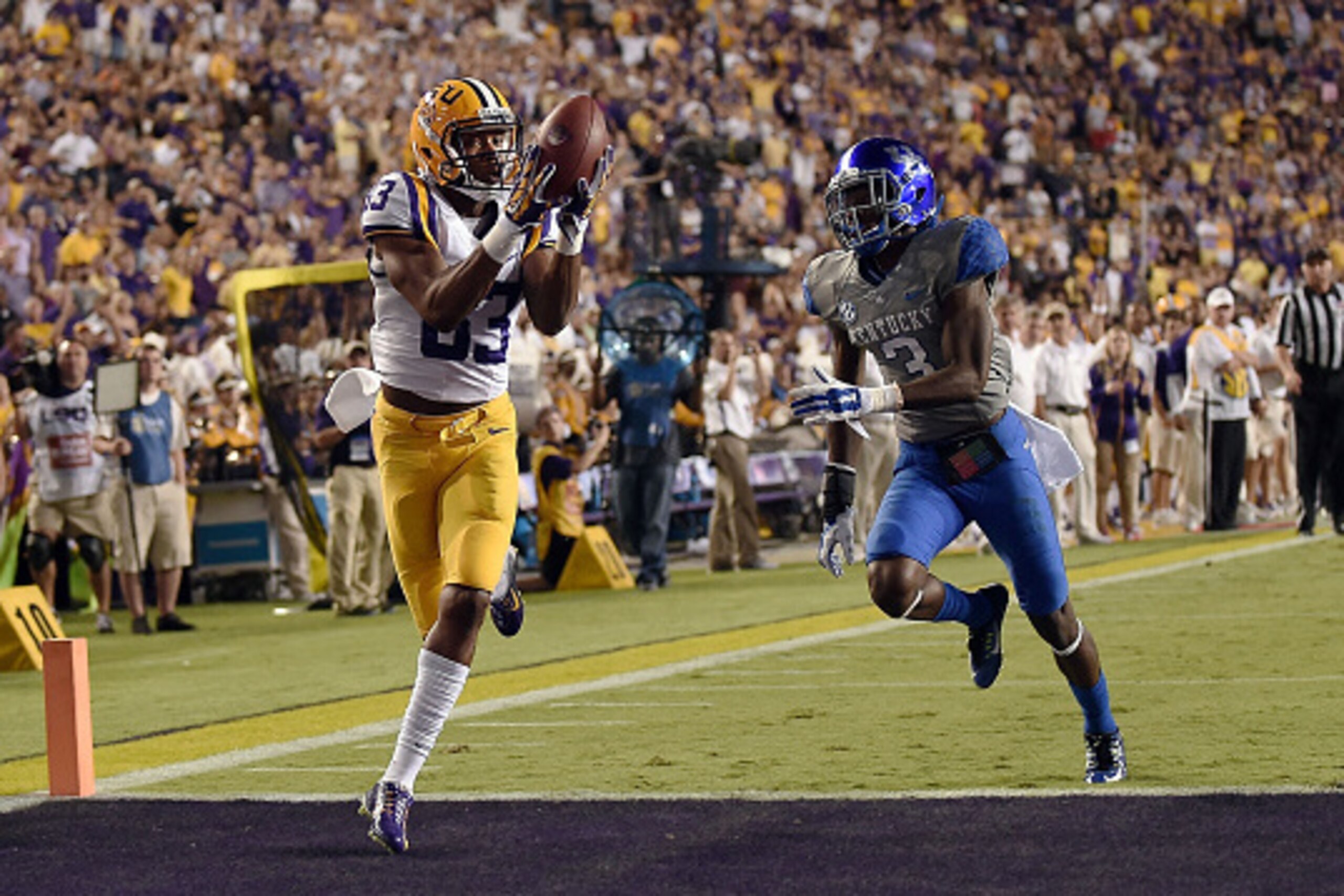 BATON ROUGE, LA - OCTOBER 18: Travin Dural #83 of the LSU Tigers catches a touchdown pass in front of Fred Tiller #3 of the Kentucky Wildcats during the second quarter of a game at Tiger Stadium on October 18, 2014 in Baton Rouge, Louisiana. (Photo by Sta