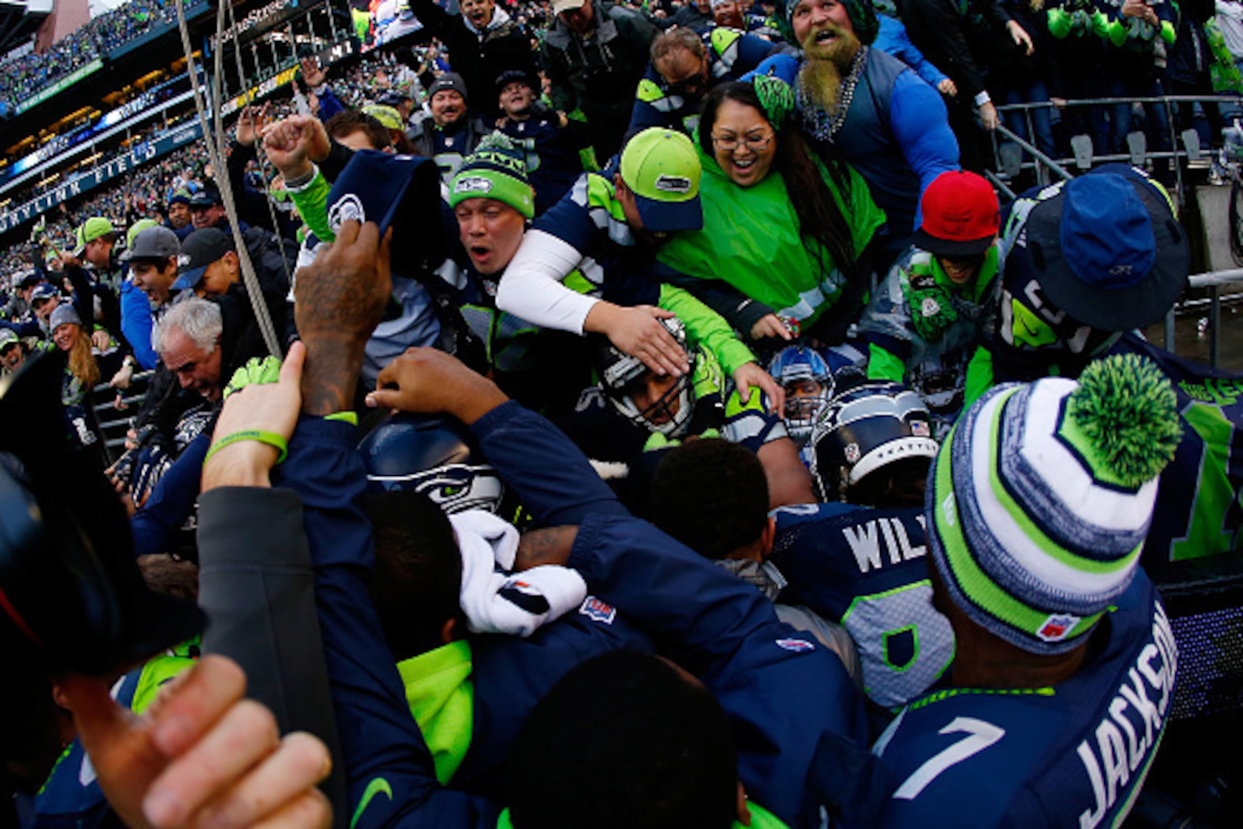 SEATTLE, WA - JANUARY 18: Seattle Seahawks  fans celebrate with Jermaine Kearse #15 of the Seattle Seahawks after Kearse caught the game winning touchdown in overtime of the 2015 NFC Championship game against the Green Bay Packers at CenturyLink Field on 