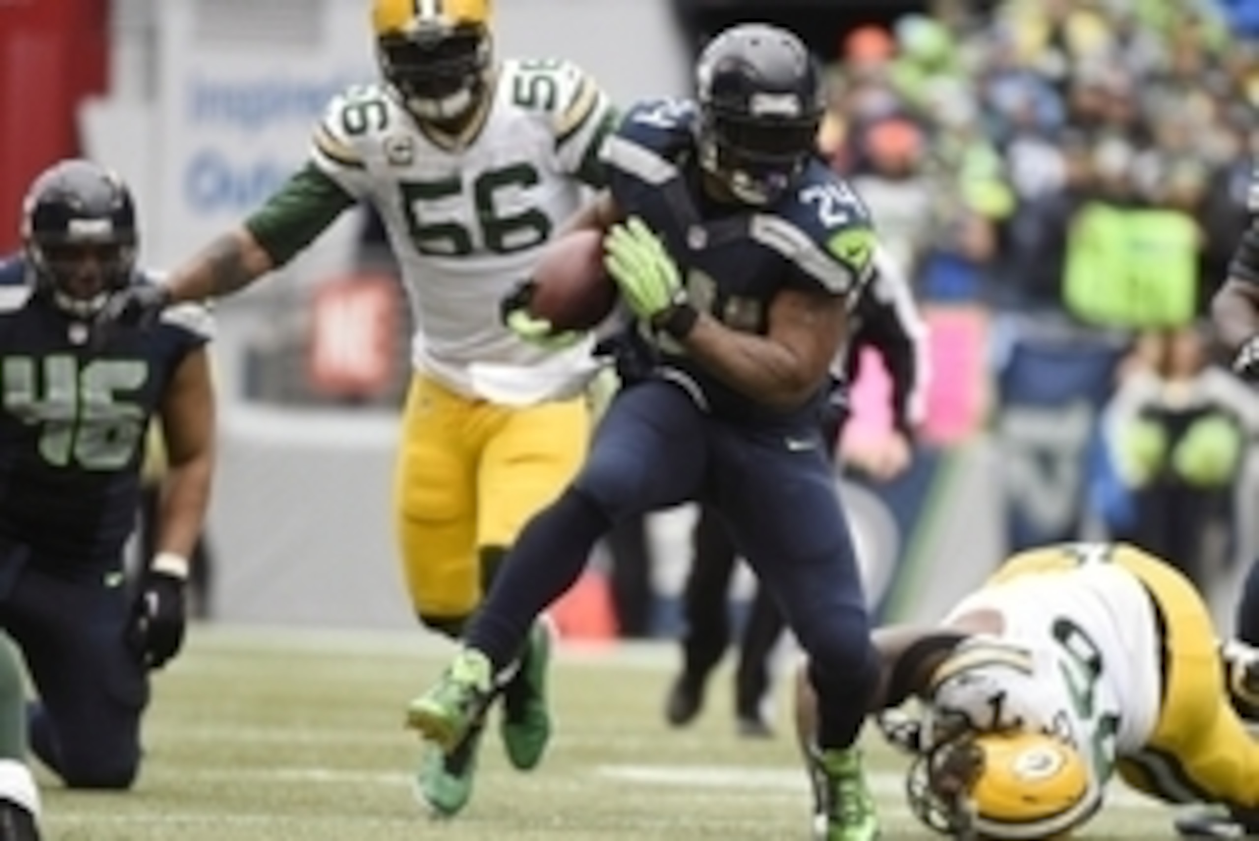 January 18, 2015; Seattle, WA, USA; Seattle Seahawks running back Marshawn Lynch (24) runs the ball ahead of  Green Bay Packers outside linebacker Julius Peppers (56) and defensive end Mike Daniels (76) during the second half in the NFC Championship game 