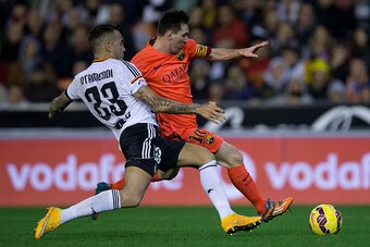 VALENCIA, SPAIN - NOVEMBER 30: Lionel Messi (R) of FC Barcelona competes for the ball with Nicolas Otamendi (L) of Valencia CF during the La Liga match between Valencia CF and FC Barcelona at Estadi de Mestalla on November 30, 2014 in Valencia, Spain.  (P