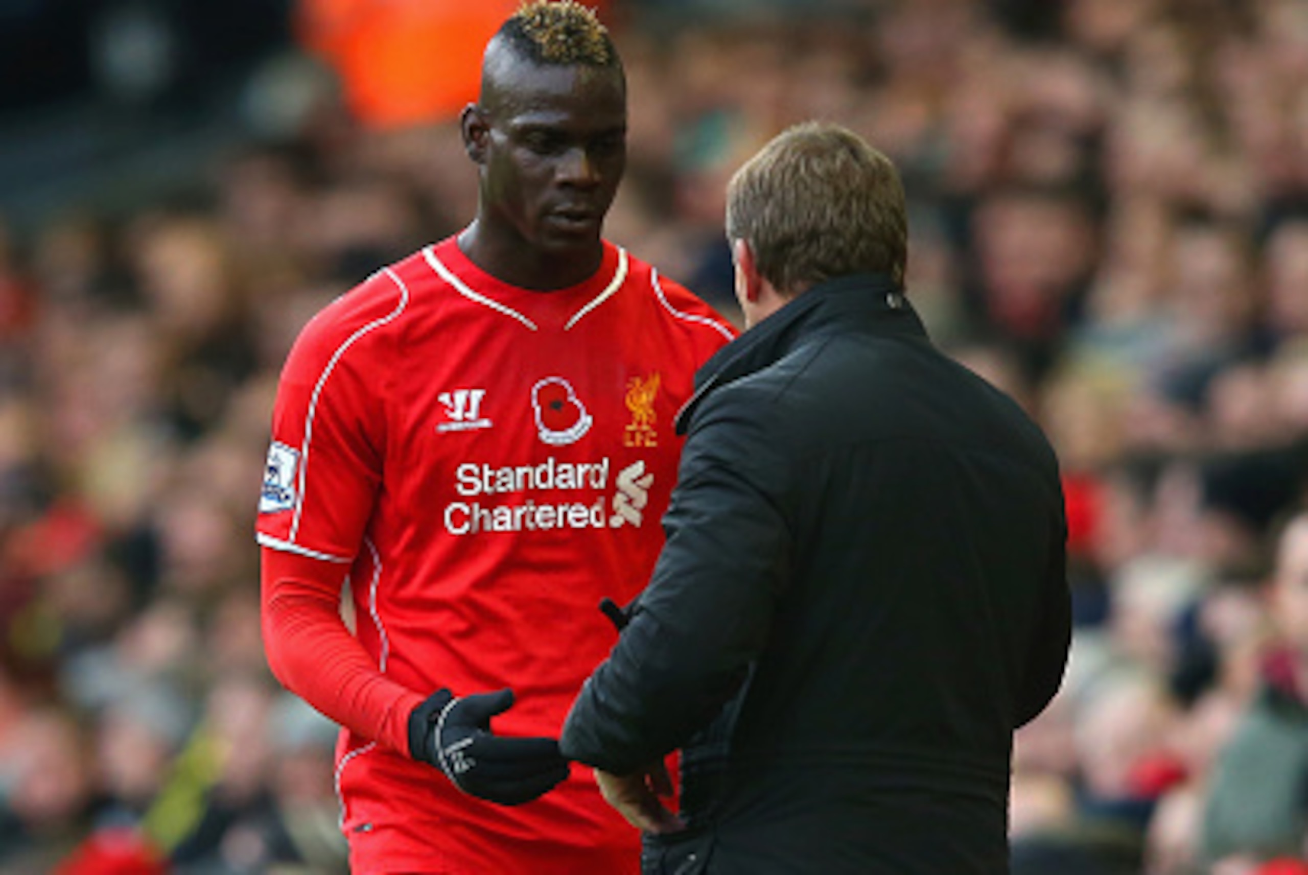 LIVERPOOL, ENGLAND - NOVEMBER 08:  Brendan Rodgers, manager of Liverpool speaks to Mario Balotelli of Liverpool is substituted during the Barclays Premier League match between Liverpool and Chelsea at Anfield on November 8, 2014 in Liverpool, England.  (P
