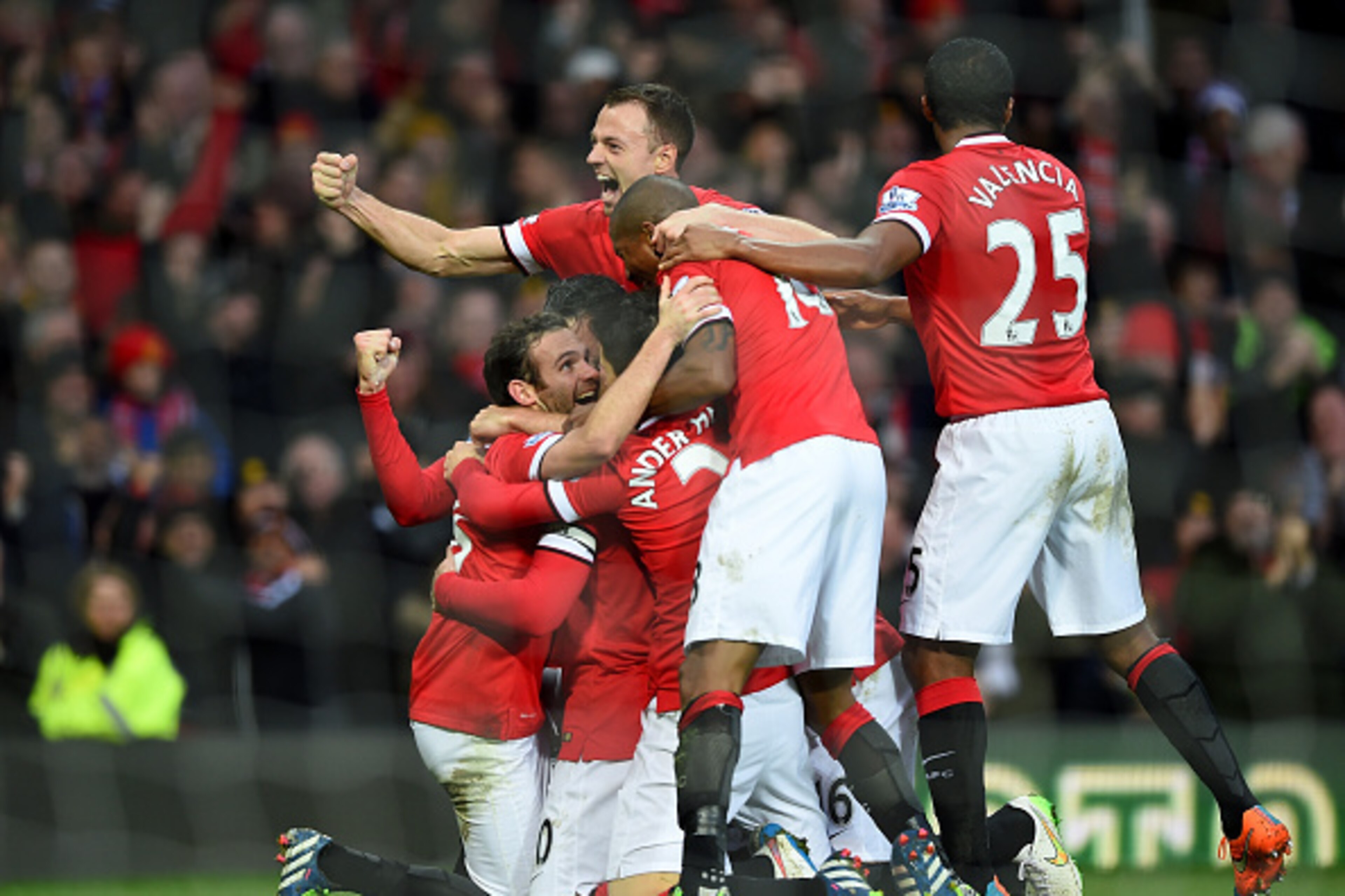 MANCHESTER, ENGLAND - DECEMBER 14:  Robin van Persie of Manchester United celebrates scoring the third goal with his team-mates during the Barclays Premier League match between Manchester United and Liverpool at Old Trafford on December 14, 2014 in Manche
