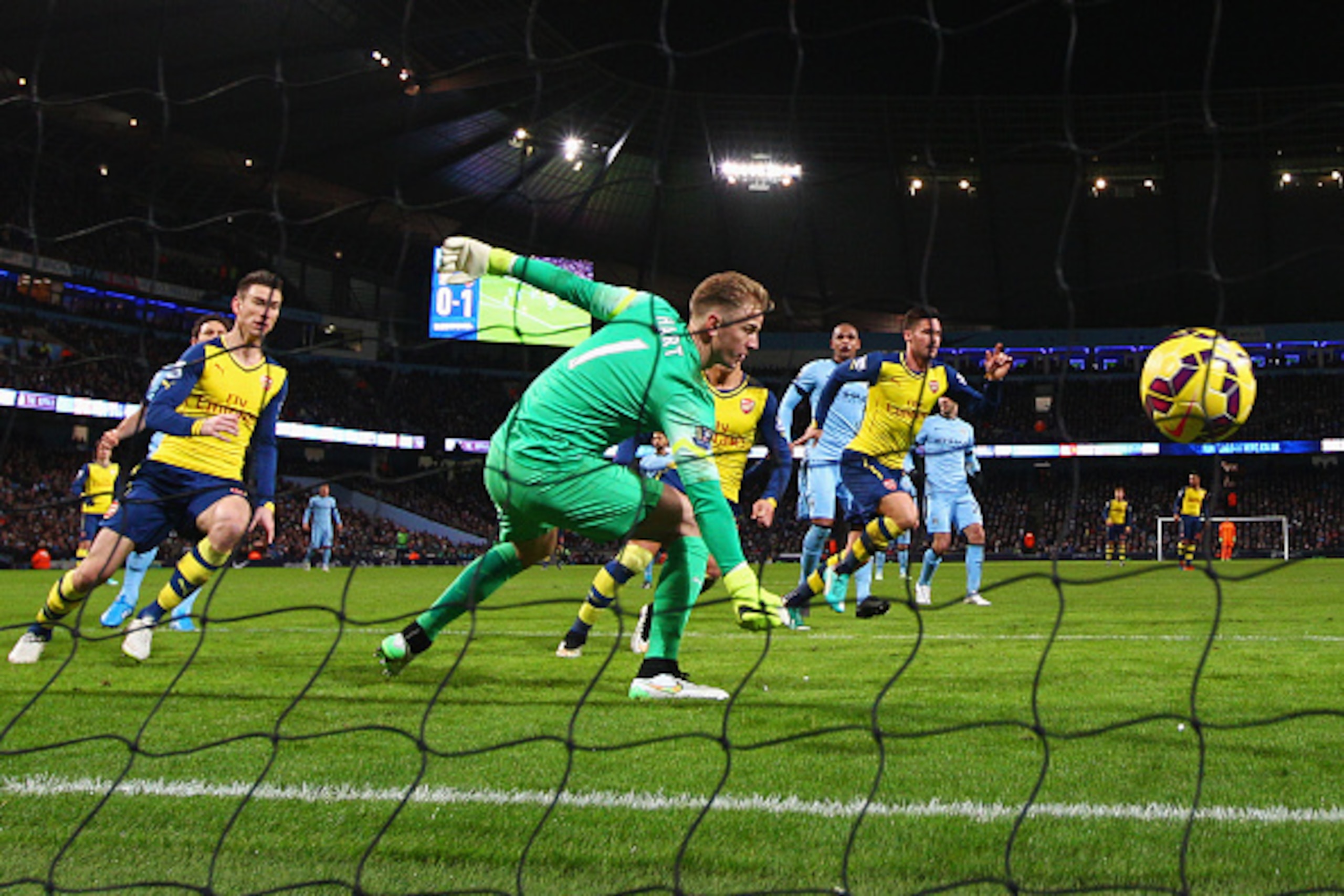 MANCHESTER, ENGLAND - JANUARY 18:  Olivier Giroud of Arsenal (12) scores their second goal with a header past goalkeeper Joe Hart of Manchester City during the Barclays Premier League match between Manchester City and Arsenal at Etihad Stadium on January 