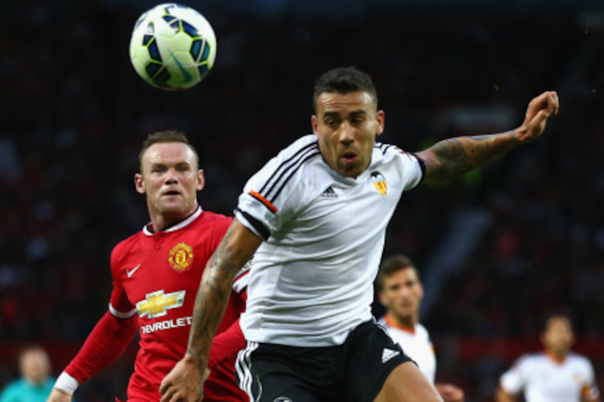 MANCHESTER, ENGLAND - AUGUST 12: Wayne Rooney of Manchester United in action with Nicolas Otamendi of Valencia during the Pre Season Friendly match between Manchester United and Valencia at Old Trafford on August 12, 2014 in Manchester, England. (Photo MANCHESTER, ENGLAND - AUGUST 12: Wayne Rooney of Manchester United in action with Nicolas Otamendi of Valencia during the Pre Season Friendly match between Manchester United and Valencia at Old Trafford on August 12, 2014 in Manchester, England. (Photo