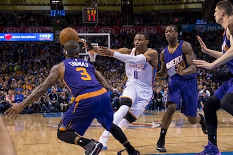 OKLAHOMA CITY, OK - DECEMBER 14: Russell Westbrook #0 of the Oklahoma City Thunder passes the ball against the Phoenix Suns at the Chesapeake Energy Arena  on December 14, 2013 in Oklahoma City, Oklahoma. NOTE TO USER:  User expressly acknowledges and agr