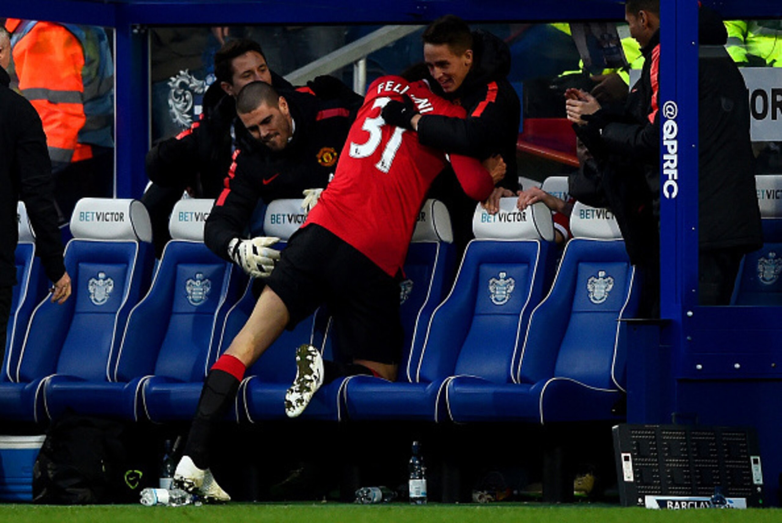 LONDON, ENGLAND - JANUARY 17:  Marouane Fellaini of Manchester United celebrates with team-mate son the bench including Adnan Januzaj and Victor Valdes during the Barclays Premier League match between Queens Park Rangers and Manchester United at Loftus Ro
