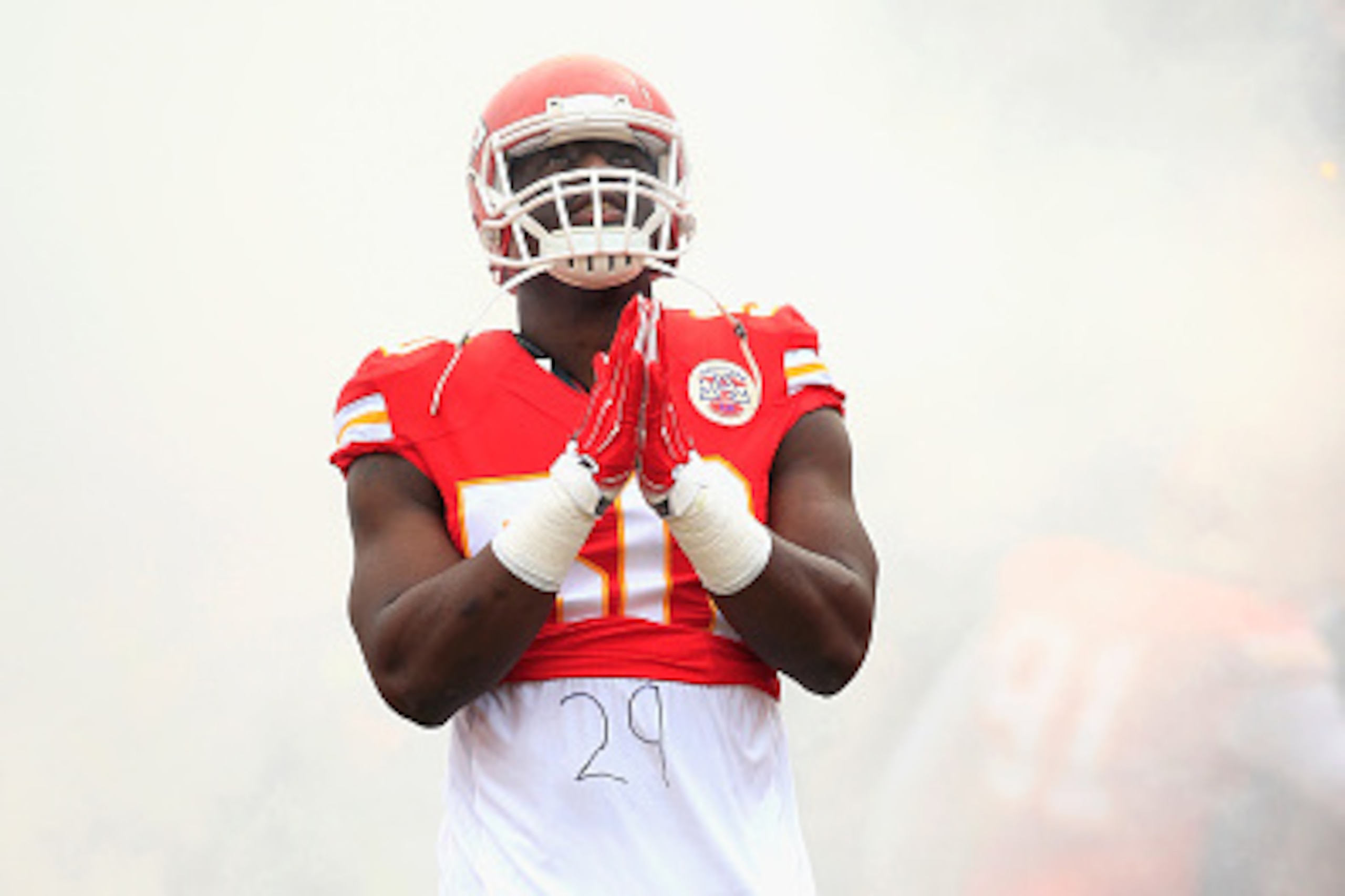 KANSAS CITY, MO - DECEMBER 14:   Justin Houston #50 of the Kansas City Chiefs gestures in a tribute to Eric Berry during player introductions before the game against the Oakland Raiders  at Arrowhead Stadium on December 14, 2014 in Kansas City, Missouri. 