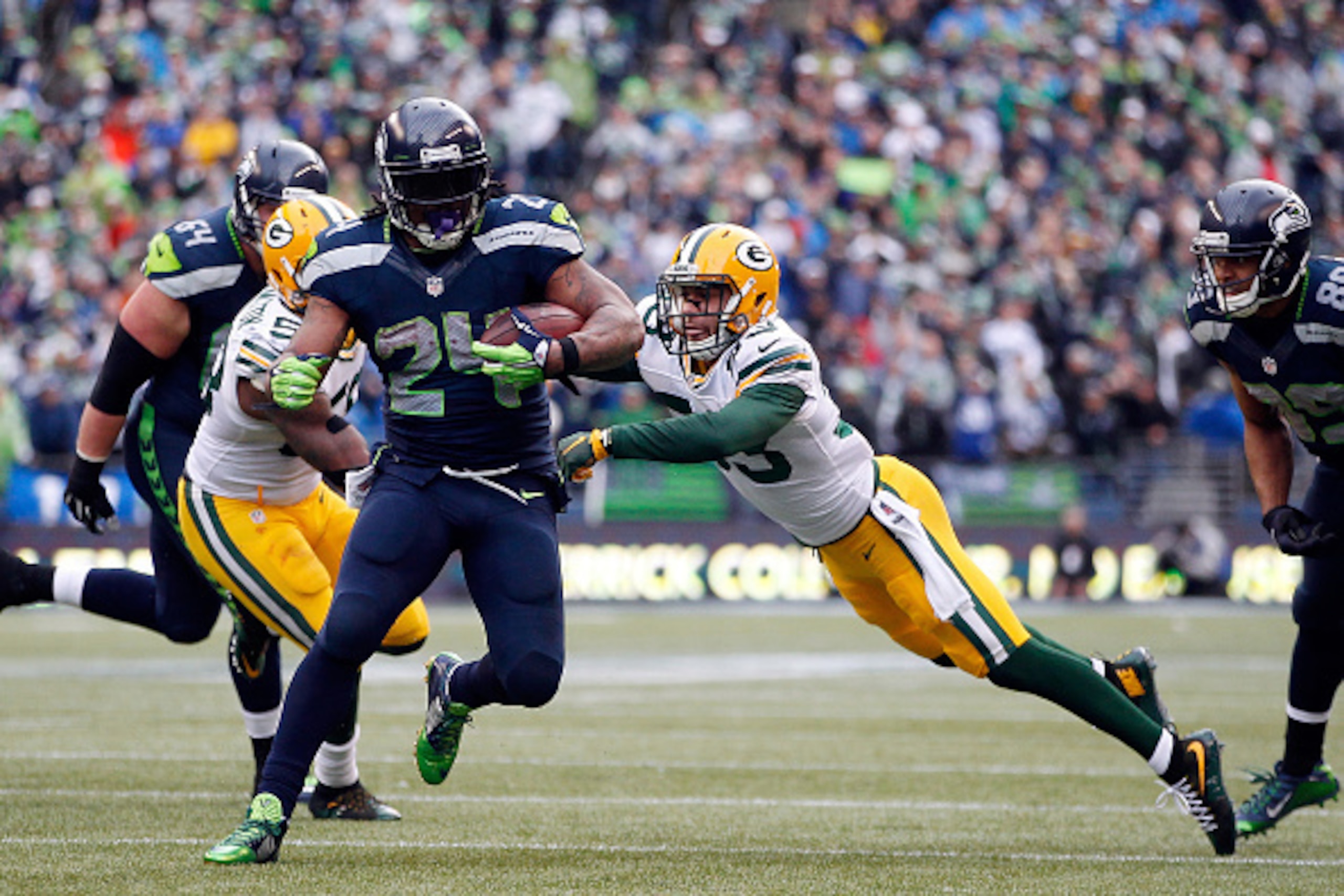 SEATTLE, WA - JANUARY 18:  Marshawn Lynch #24 of the Seattle Seahawks runs the ball in for a touchdown during the fourth quarter of the 2015 NFC Championship game against the Green Bay Packers at CenturyLink Field on January 18, 2015 in Seattle, Washingto