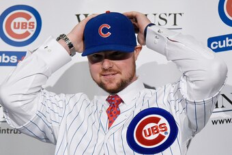 CHICAGO, IL - DECEMBER 15:  Pitcher Jon Lester puts on a Cubs hat during an introduction press conference by the Chicago Cubs on December 15, 2014  in Chicago, Illinois. (Photo by David Banks/Getty Images)