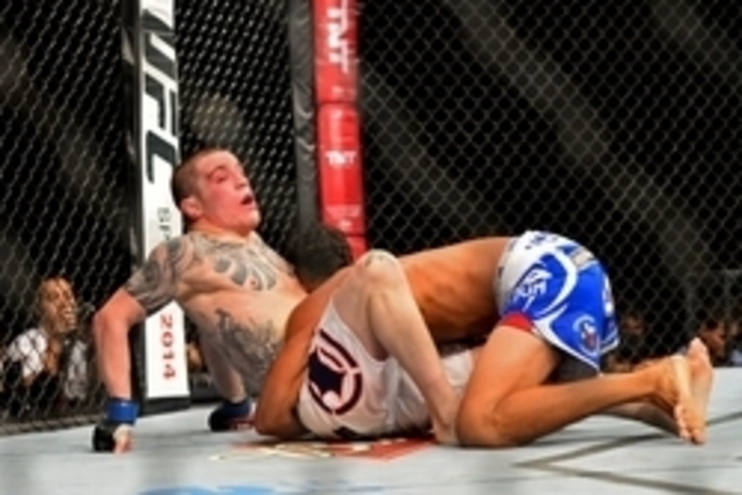 Feb 15, 2014; Jaragua do Sul, SC, Brazil; Charles Oliveira (red gloves) fights Andy Ogle (blue gloves) during UFC Fight Night Machida vs Mousasi at Arena Jaragua. Mandatory Credit: Jason Silva-USA TODAY Sports