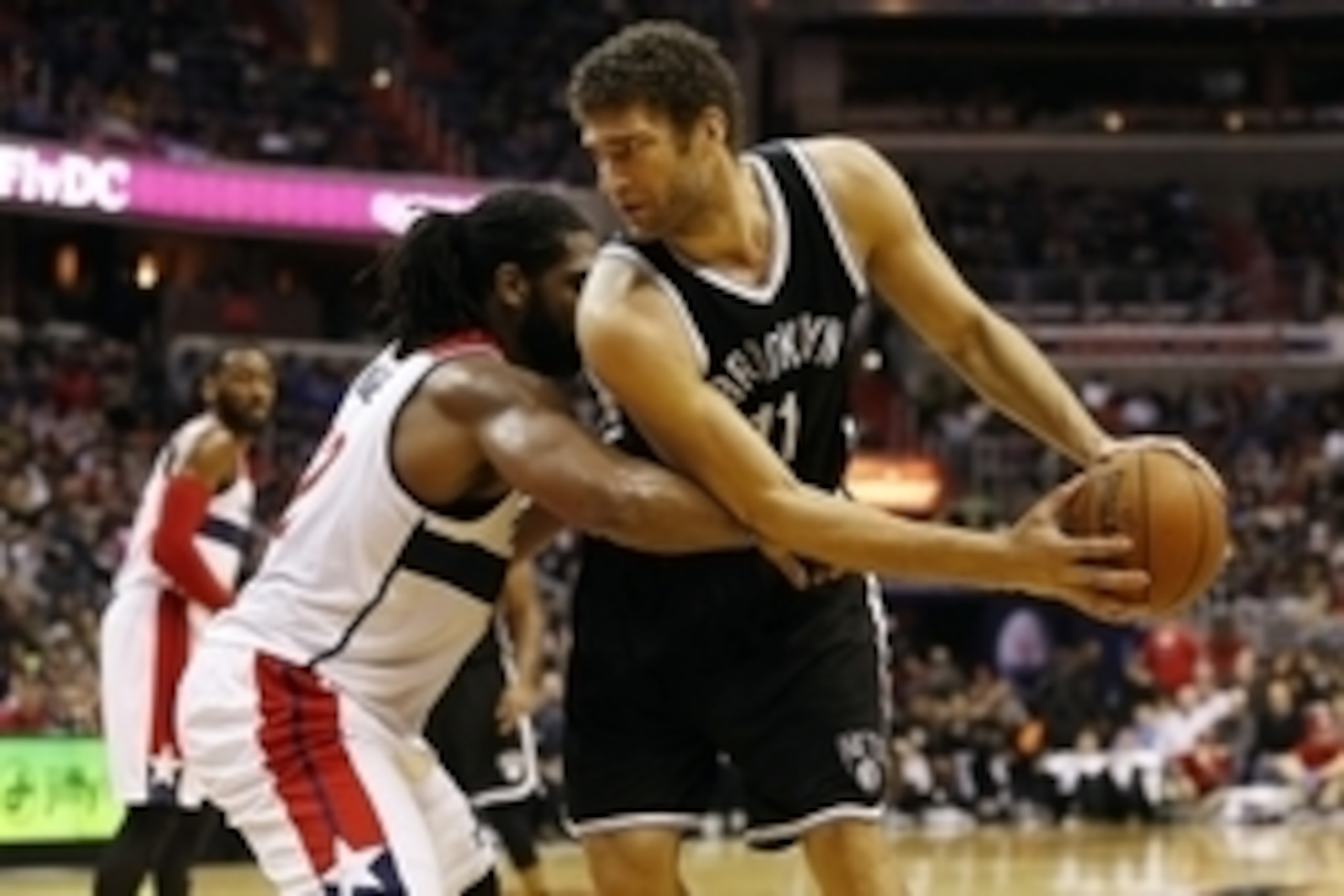 Jan 16, 2015; Washington, DC, USA; Brooklyn Nets center Brook Lopez (11) holds the ball as Washington Wizards forward Nene (42) defends in the third quarter at Verizon Center. The Nets won 102-80. Mandatory Credit: Geoff Burke-USA TODAY Sports