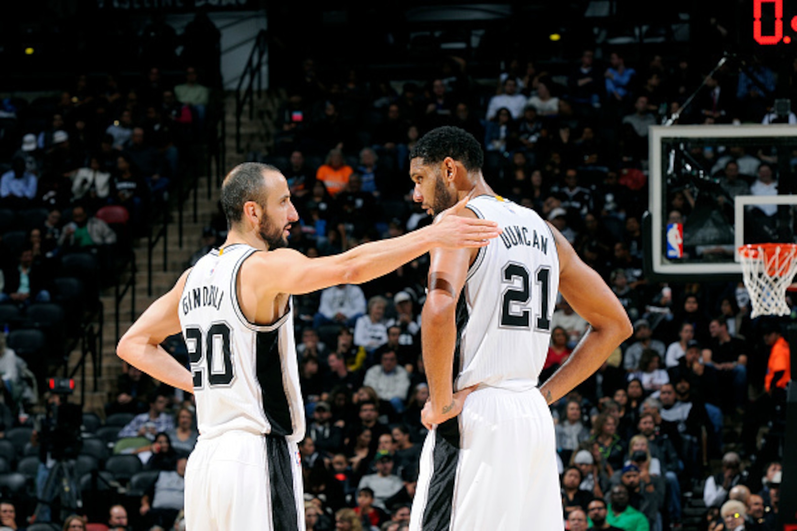 SAN ANTONIO, TX - NOVEMBER 5: Manu Ginobili #20 and Tim Duncan #21 of the San Antonio Spurs speak during a game against the Atlanta Hawks at the AT&T Center on November 5, 2014 in San Antonio, Texas. NOTE TO USER: User expressly acknowledges and agrees th