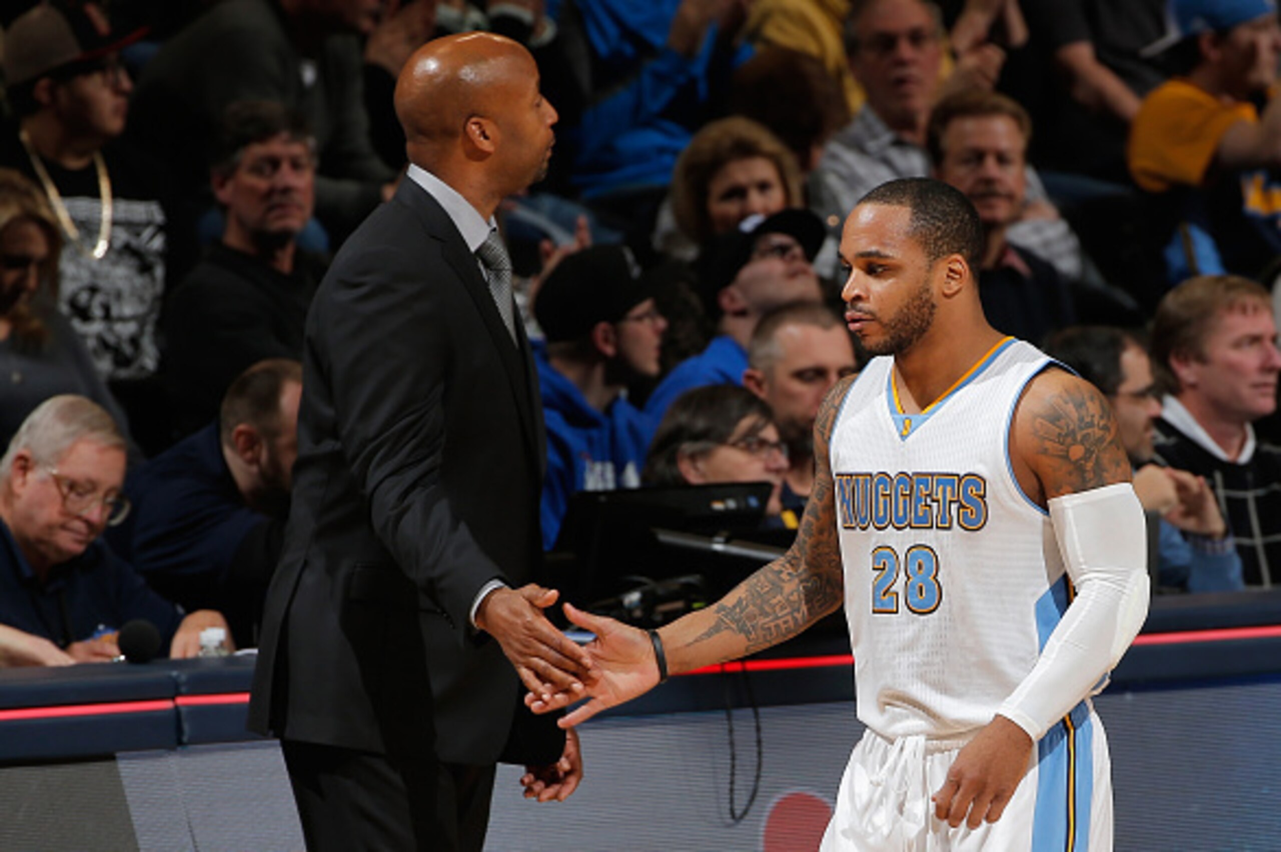 DENVER, CO - JANUARY 17:  Jameer Nelson #28 of the Denver Nuggets is welcomed to the bench by head coach Brian Shaw of the Denver Nuggets as they face the Minnesota Timberwolves at Pepsi Center on January 17, 2015 in Denver, Colorado. The Timberwolves def
