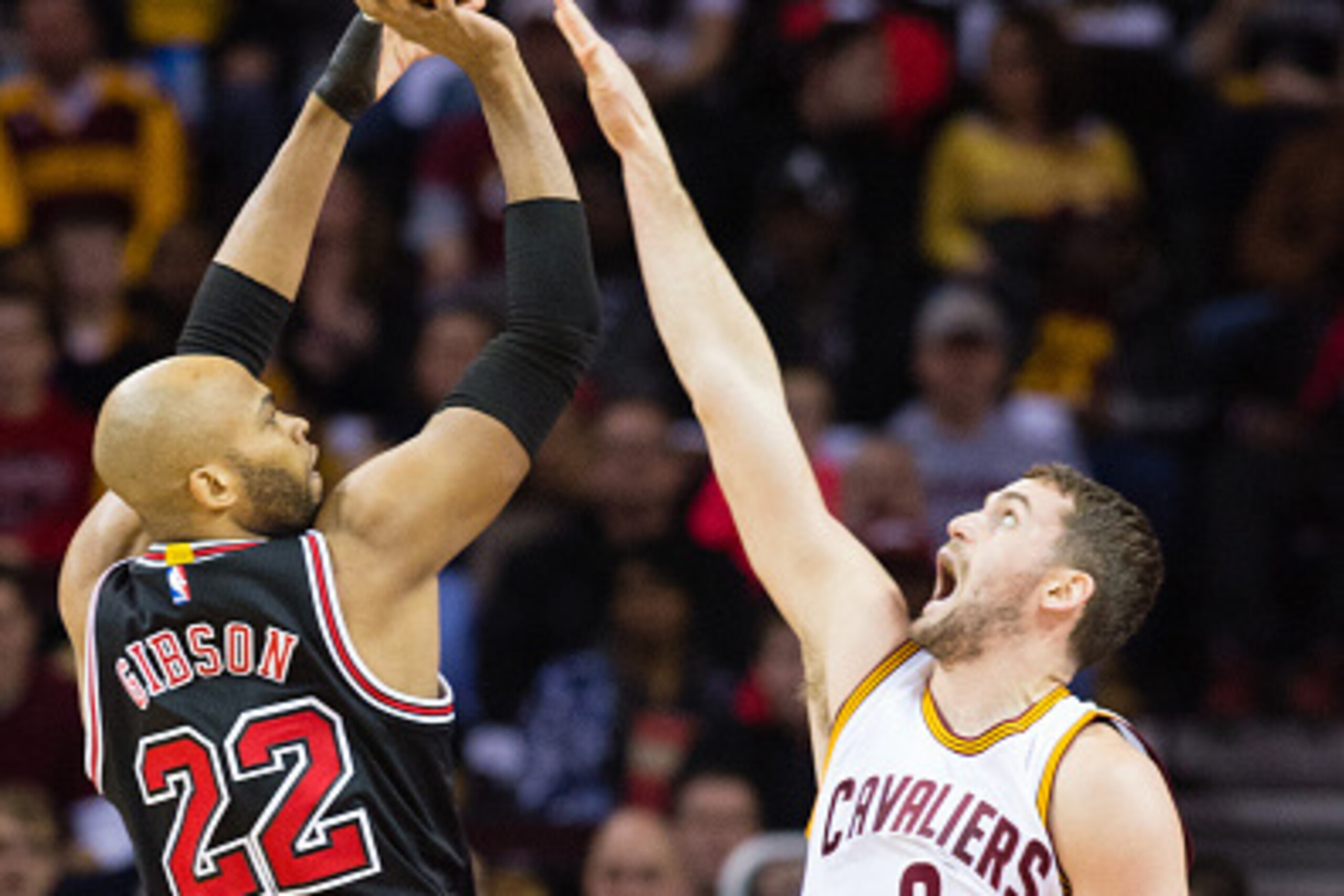 CLEVELAND, OH - JANUARY 19: Taj Gibson #22 of the Chicago Bulls shoots over Kevin Love #0 of the Cleveland Cavaliers during the first half at Quicken Loans Arena on January 19, 2015 in Cleveland, Ohio. NOTE TO USER: User expressly acknowledges and agrees 