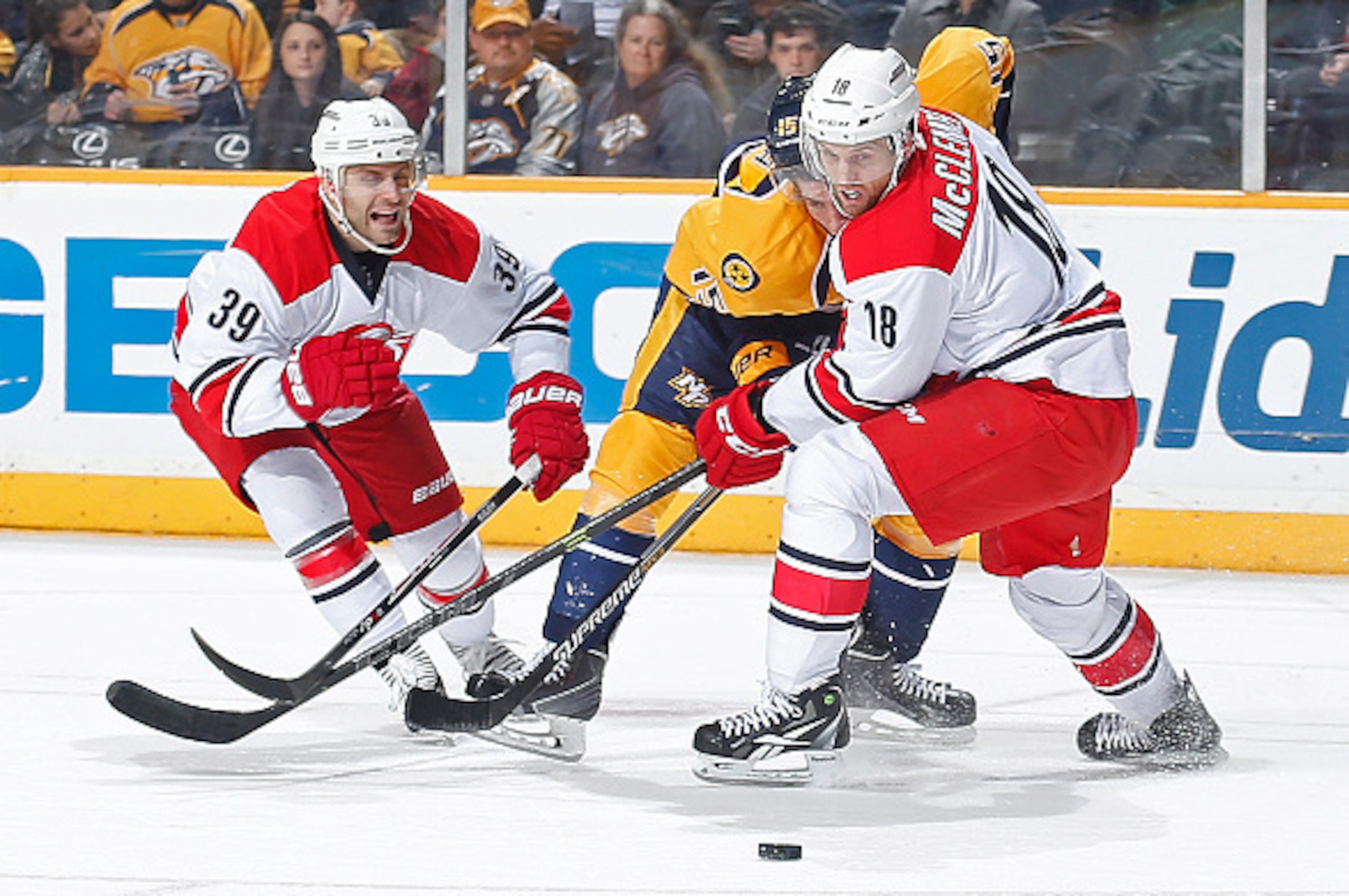 NASHVILLE, TN - JANUARY 6: Jay McClement #18 and Patrick Dwyer #39 of the Carolina Hurricanes battle against Craig Smith #15 of the Nashville Predators during an NHL game at Bridgestone Arena on January 6, 2015 in Nashville, Tennessee. (Photo by John Russ NASHVILLE, TN - JANUARY 6: Jay McClement #18 and Patrick Dwyer #39 of the Carolina Hurricanes battle against Craig Smith #15 of the Nashville Predators during an NHL game at Bridgestone Arena on January 6, 2015 in Nashville, Tennessee. (Photo by John Russ