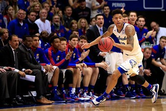 LAWRENCE, KS - JANUARY 19:  Kelly Oubre Jr. #12 of the Kansas Jayhawks controls the ball during the game against the Oklahoma Sooners at Allen Fieldhouse on January 19, 2015 in Lawrence, Kansas.  (Photo by Jamie Squire/Getty Images)