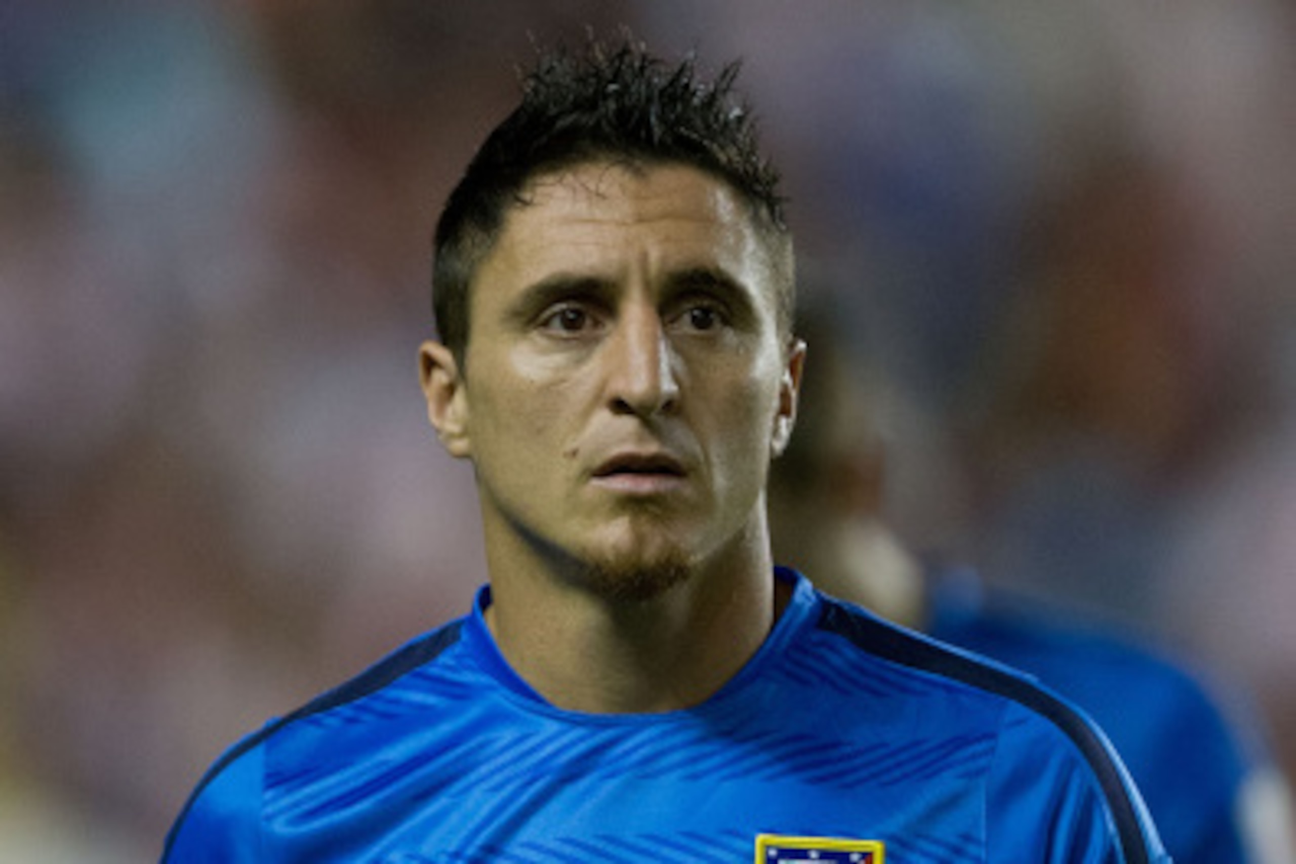 MADRID, SPAIN - AUGUST 25: Cristian Rodriguez alias El Cebolla of Atletico de Madrid walks to the bench prior to start the La Liga match between Rayo Vallecano de Madrid and Club Atletico de Madrid at Estadio de Vallecas on August 25, 2014 in Madrid, Spai