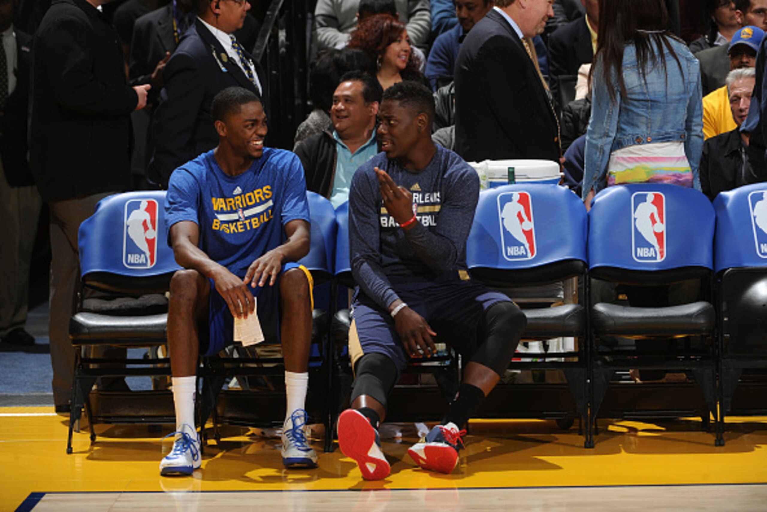 OAKLAND, CA - DECEMBER 4:  Brothers Justin Holiday of the Golden State Warriors chats with Jrue Holiday #11 of the New Orleans Pelicans prior to the game on December 4, 2014 at Oracle Arena in Oakland, California. NOTE TO USER: User expressly acknowledges