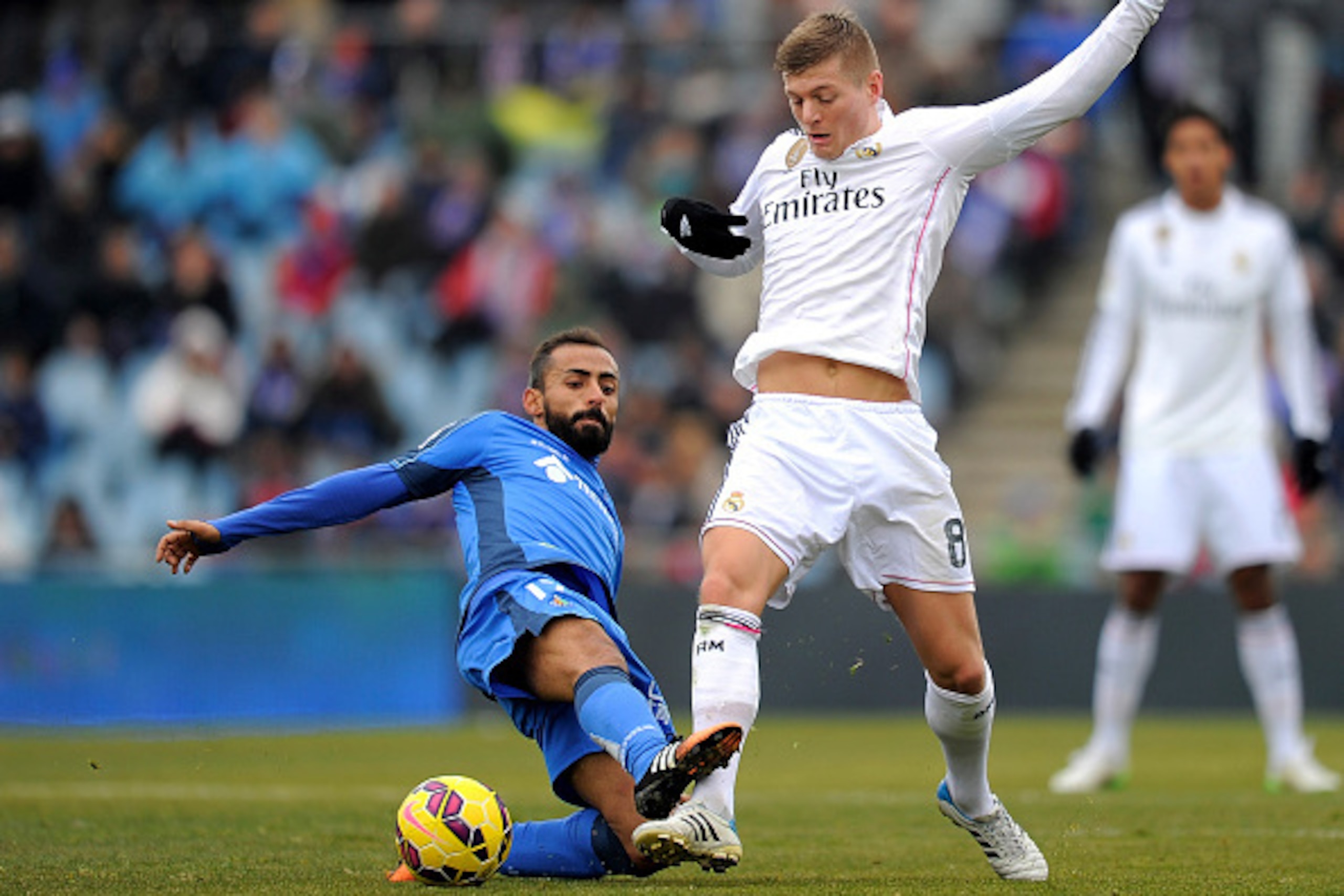 GETAFE, SPAIN - JANUARY 18:  Toni Kroos of Real Madrid is tackled by Diego Castro of Getafe CF during the La Liga match between Getafe CF and Real Madrid CF at Coliseum Alfonso Perez stadium on January 18, 2015 in Getafe, Spain.  (Photo by Denis Doyle/Get