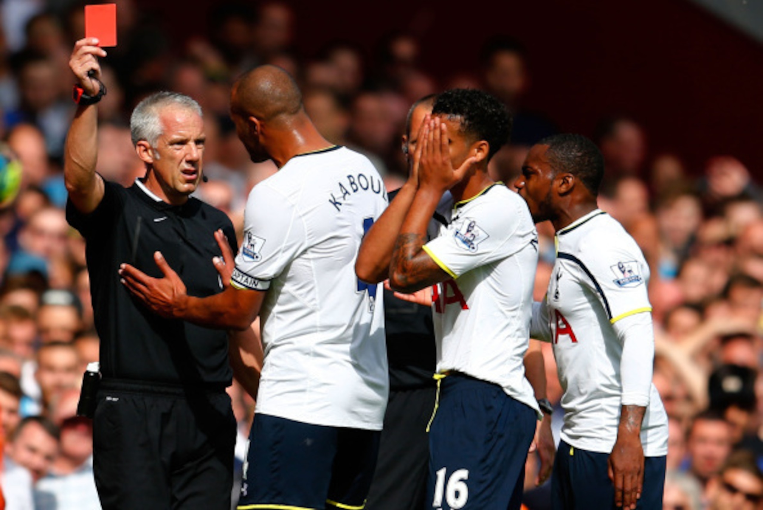 LONDON, ENGLAND - AUGUST 16:  Kyle Naughton of Spurs reacts after receiving a red card for handball as Younes Kaboul of Spurs remenstrates with referee Chris Foy during the Barclays Premier League match between West Ham United and Tottenham Hotspur at Bol