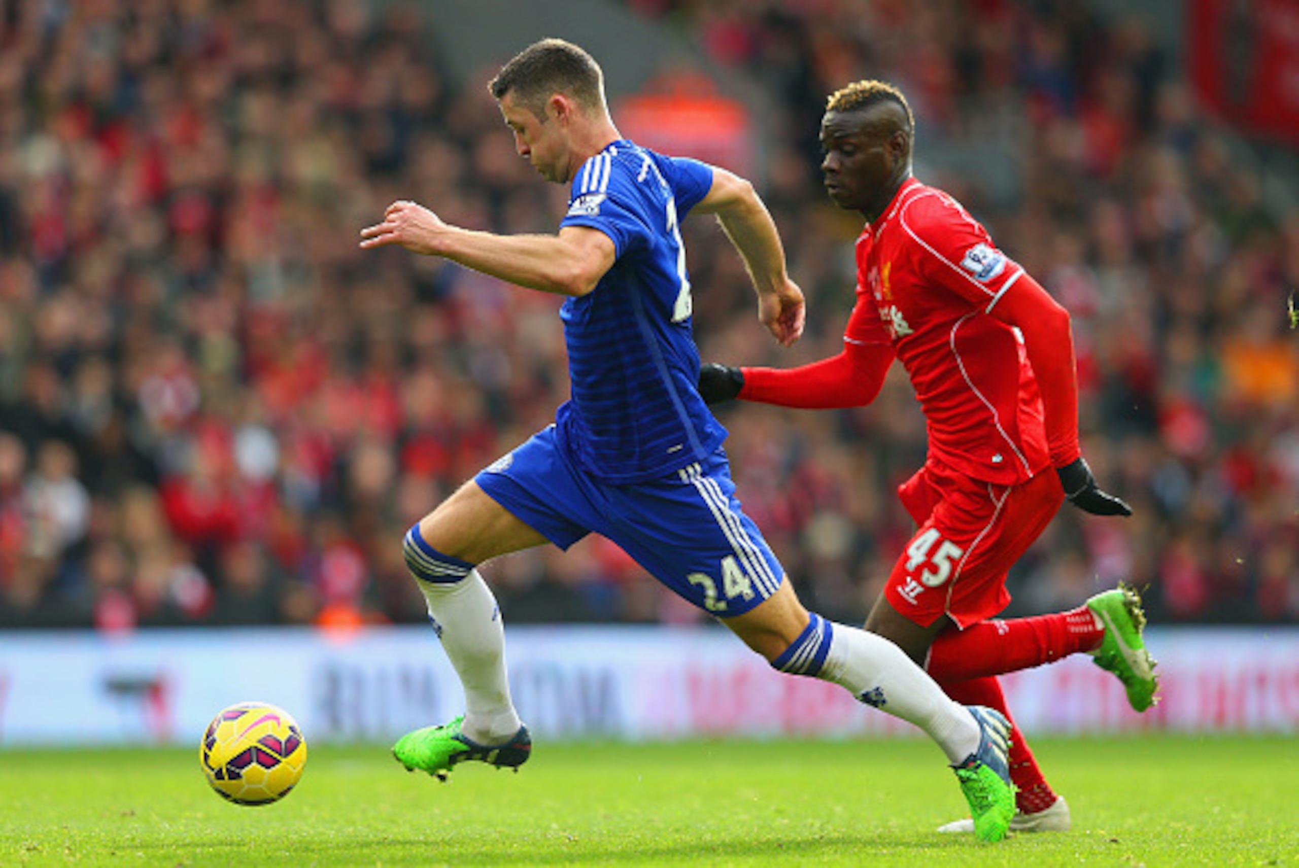 LIVERPOOL, ENGLAND - NOVEMBER 08:  Mario Balotelli of Liverpool closes down Gary Cahill of Chelsea during the Barclays Premier League match between Liverpool and Chelsea at Anfield on November 8, 2014 in Liverpool, England.  (Photo by Alex Livesey/Getty I