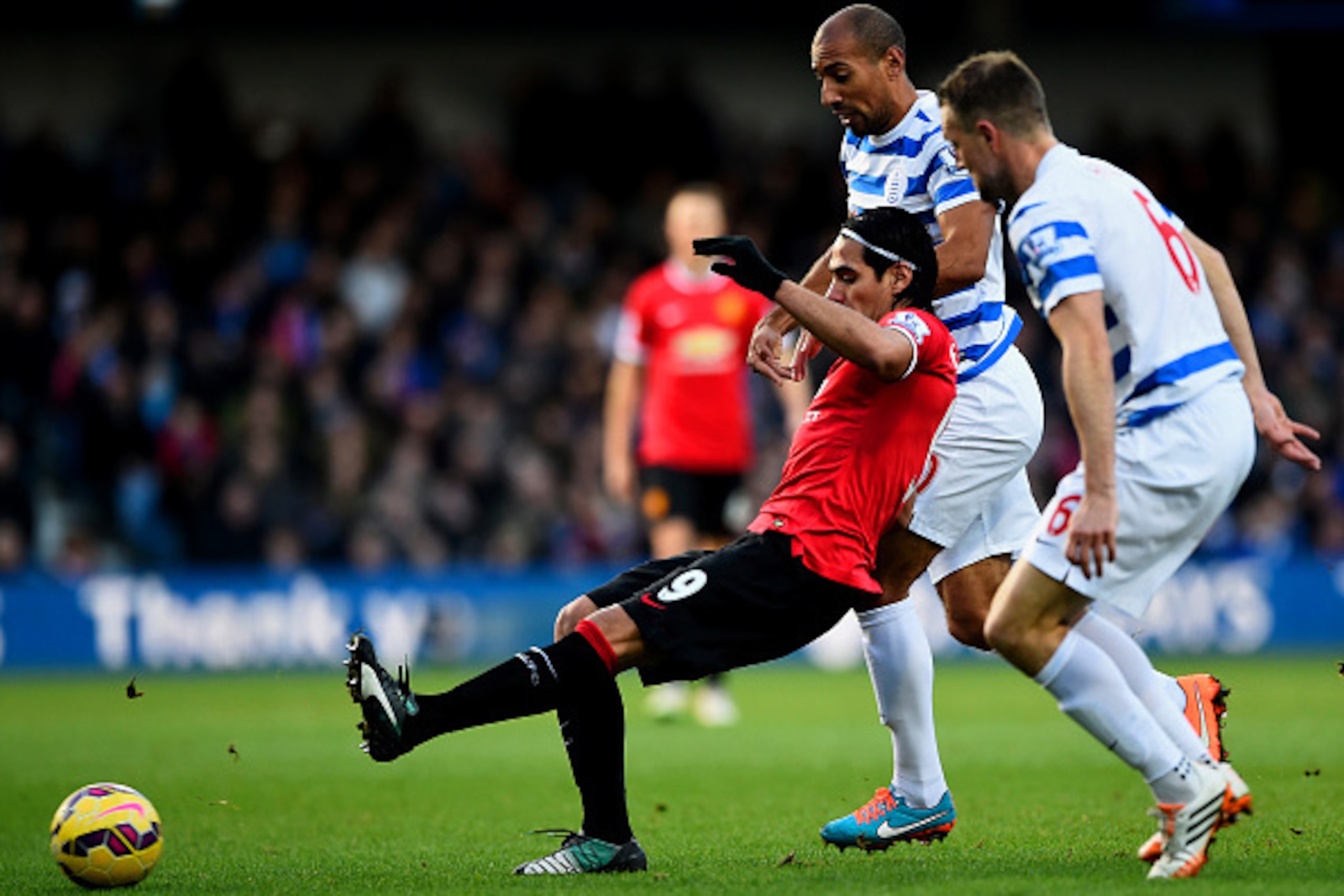 LONDON, ENGLAND - JANUARY 17:  Radamel Falcao Garcia of Manchester United passes the ball under pressure from Clint Hill and Karl Henry of QPR during the Barclays Premier League match between Queens Park Rangers and Manchester United at Loftus Road on Jan