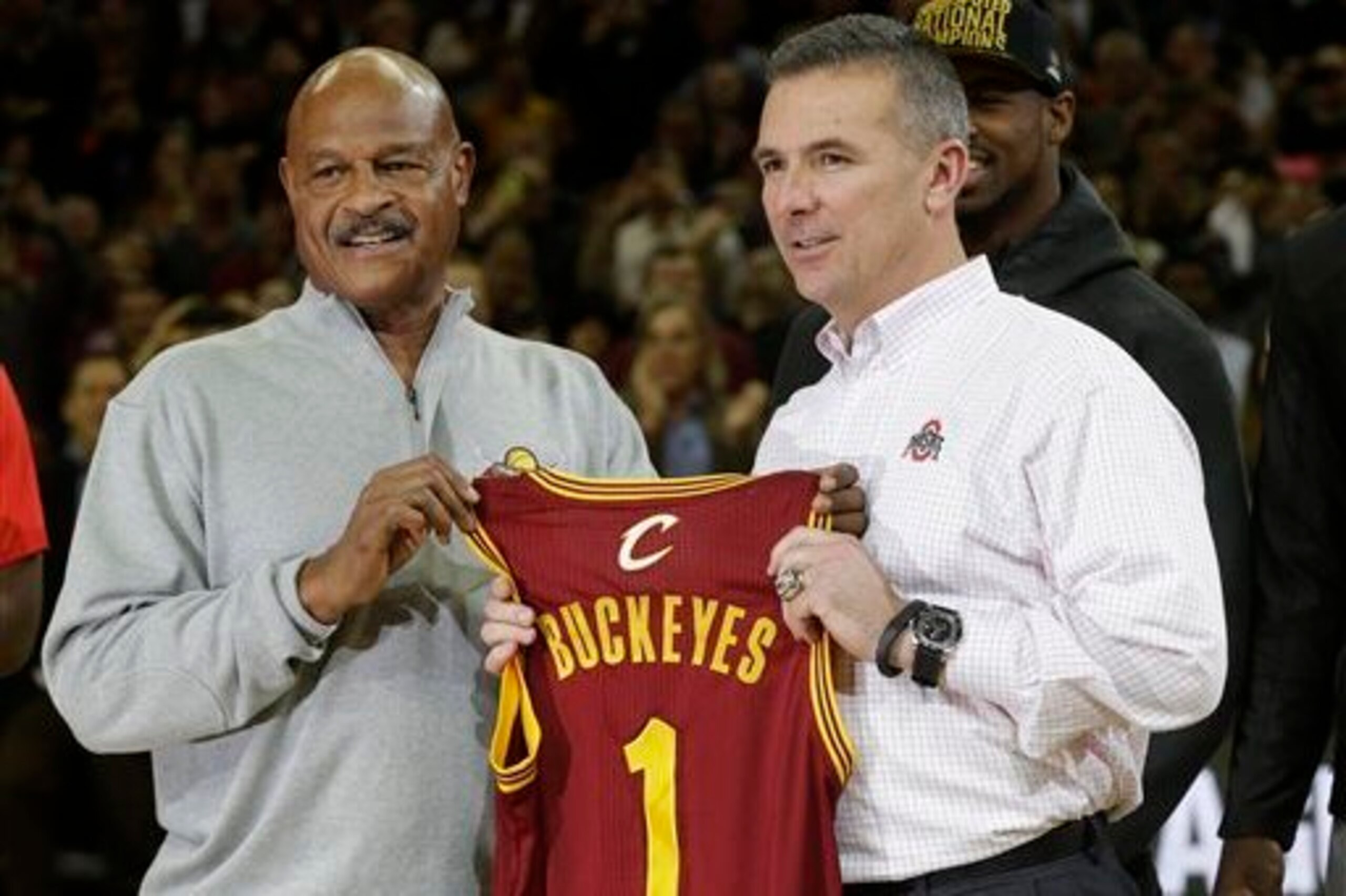 Cleveland Cavaliers legend Austin Carr presents Urban Meyer with a jersey. Cleveland Cavaliers legend Austin Carr presents Urban Meyer with a jersey.