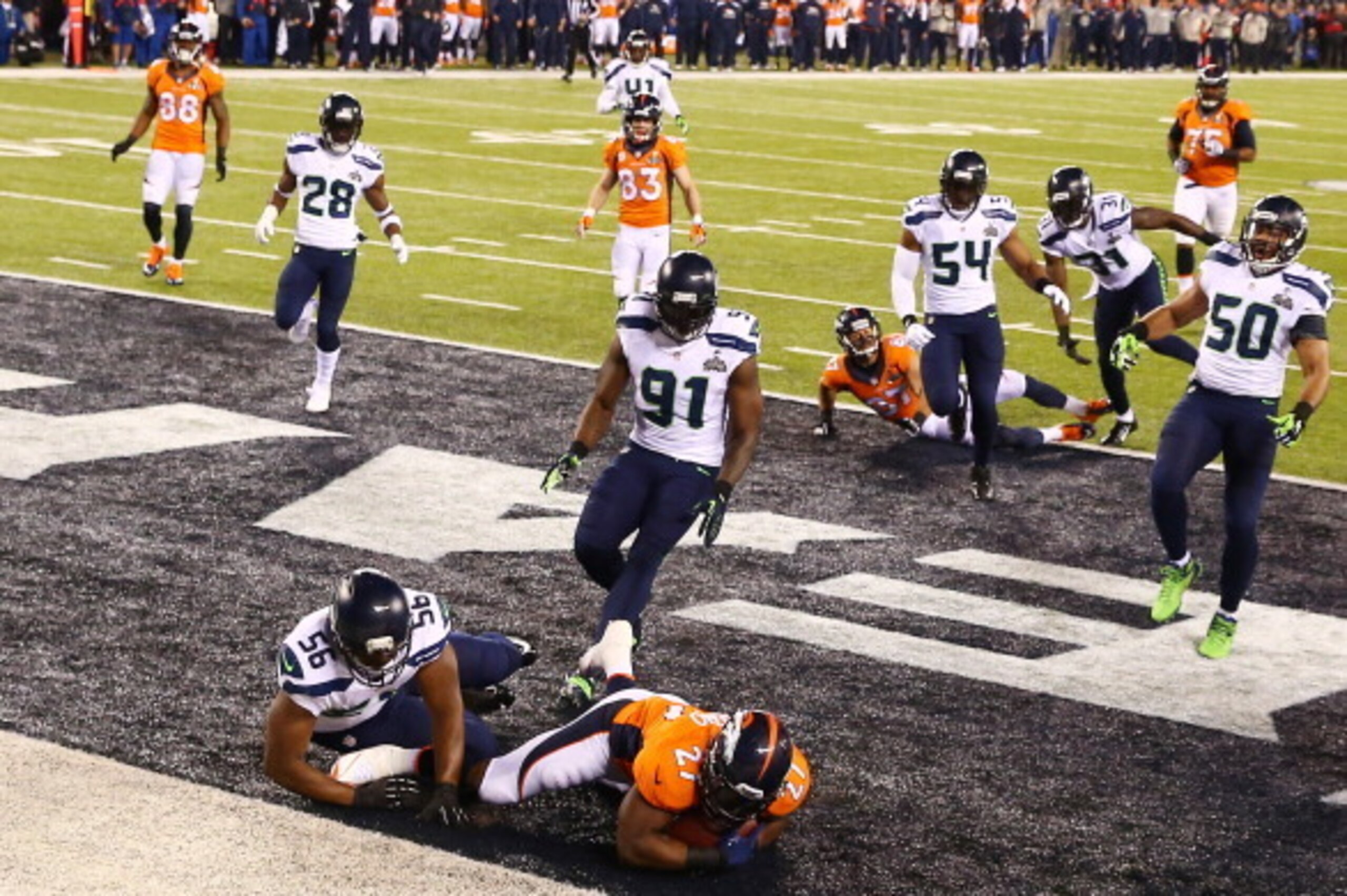 EAST RUTHERFORD, NJ - FEBRUARY 02:  Running back Knowshon Moreno #27 of the Denver Broncos recovers the ball in the endzone for a safety against the Seattle Seahawks during the first quarter of Super Bowl XLVIII at MetLife Stadium on February 2, 2014 in E
