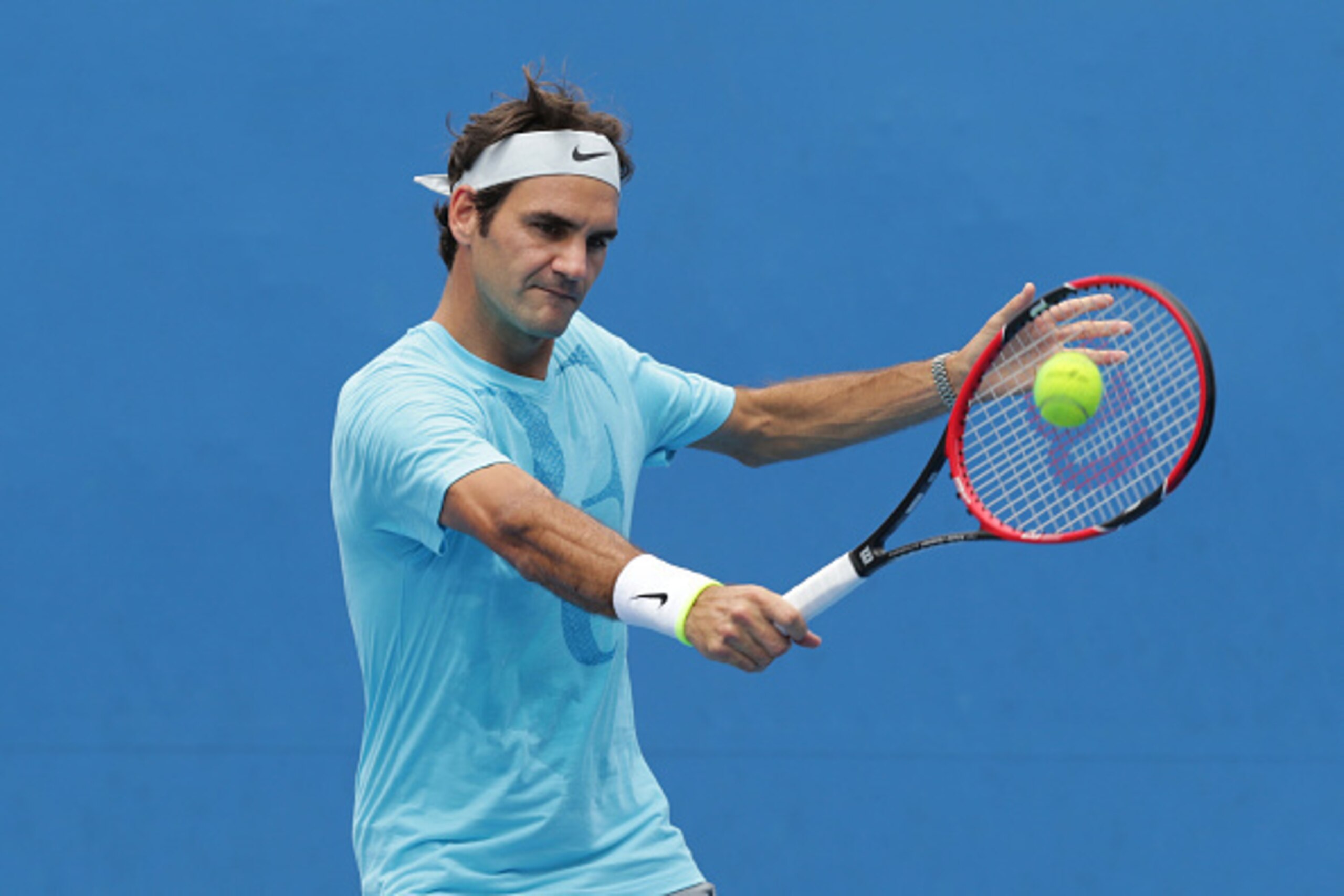 MELBOURNE, AUSTRALIA - JANUARY 20:  Roger Federer of Switzerland plays a backhand during a practice session during day two of the 2015 Australian Open at Melbourne Park on January 20, 2015 in Melbourne, Australia.  (Photo by Wayne Taylor/Getty Images)