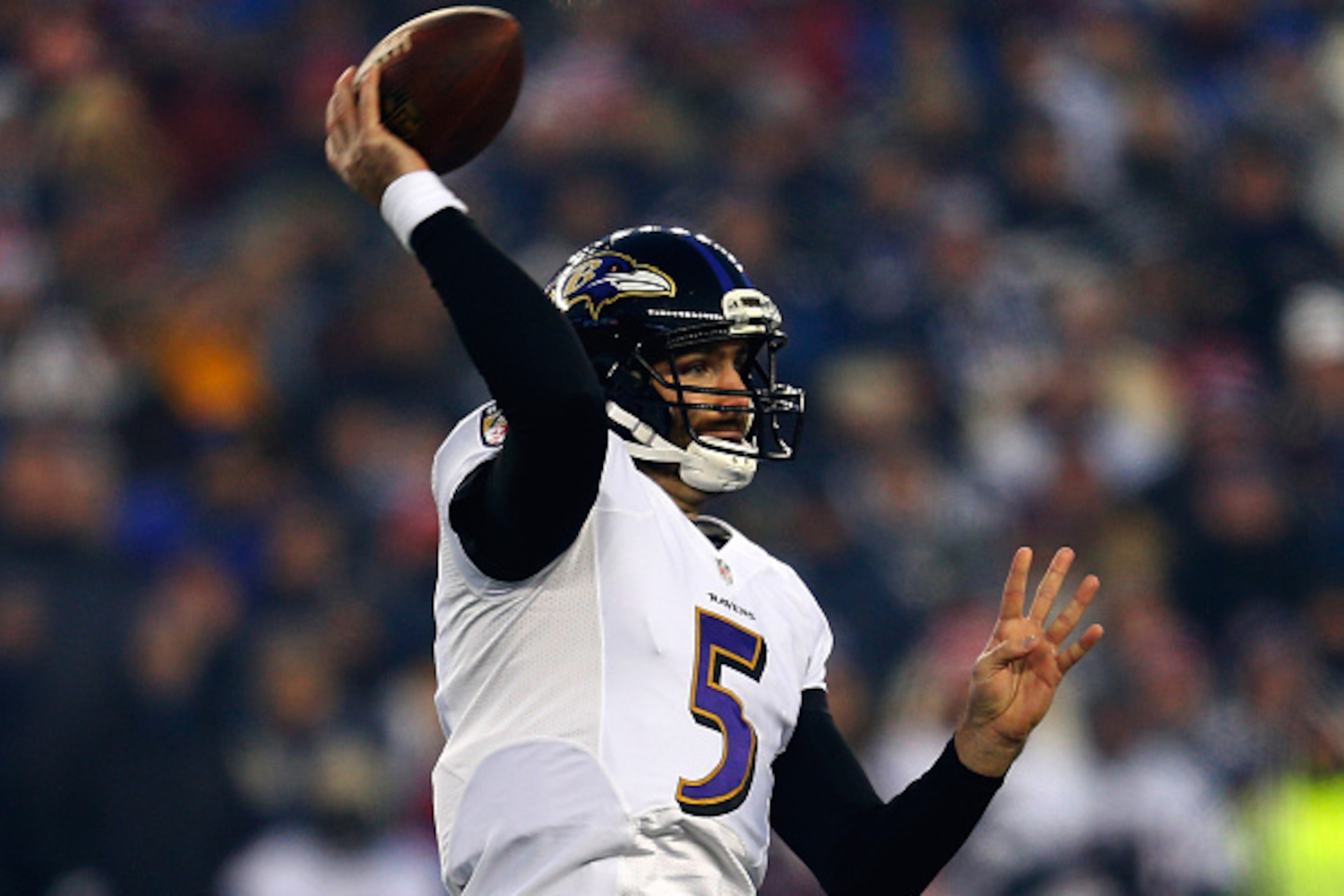 FOXBORO, MA - JANUARY 10:  Joe Flacco #5 of the Baltimore Ravens looks to pass in the first quarter against the New England Patriots during the 2014 AFC Divisional Playoffs game at Gillette Stadium on January 10, 2015 in Foxboro, Massachusetts.  (Photo by